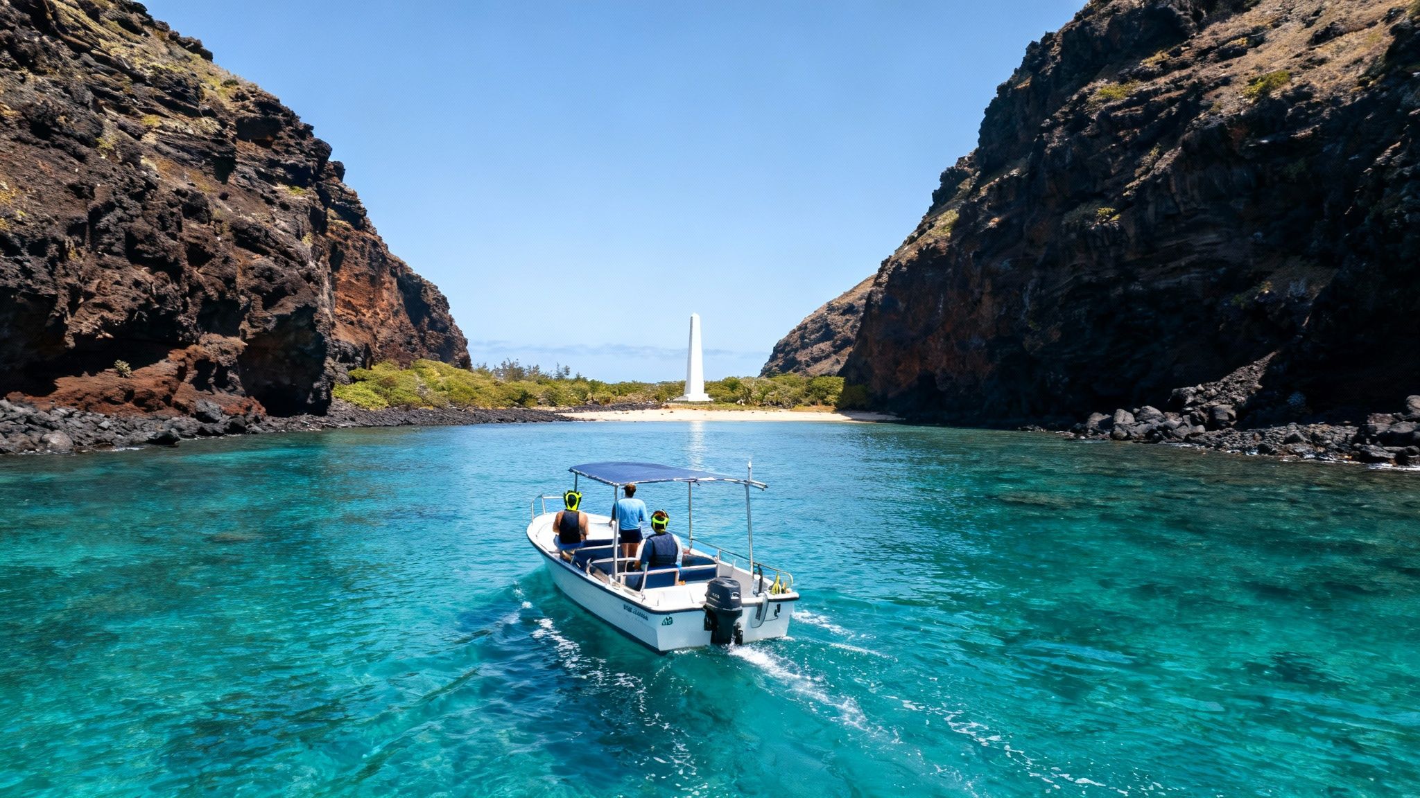 A boat carrying three people navigates clear turquoise waters towards a sandy beach with a white monument.