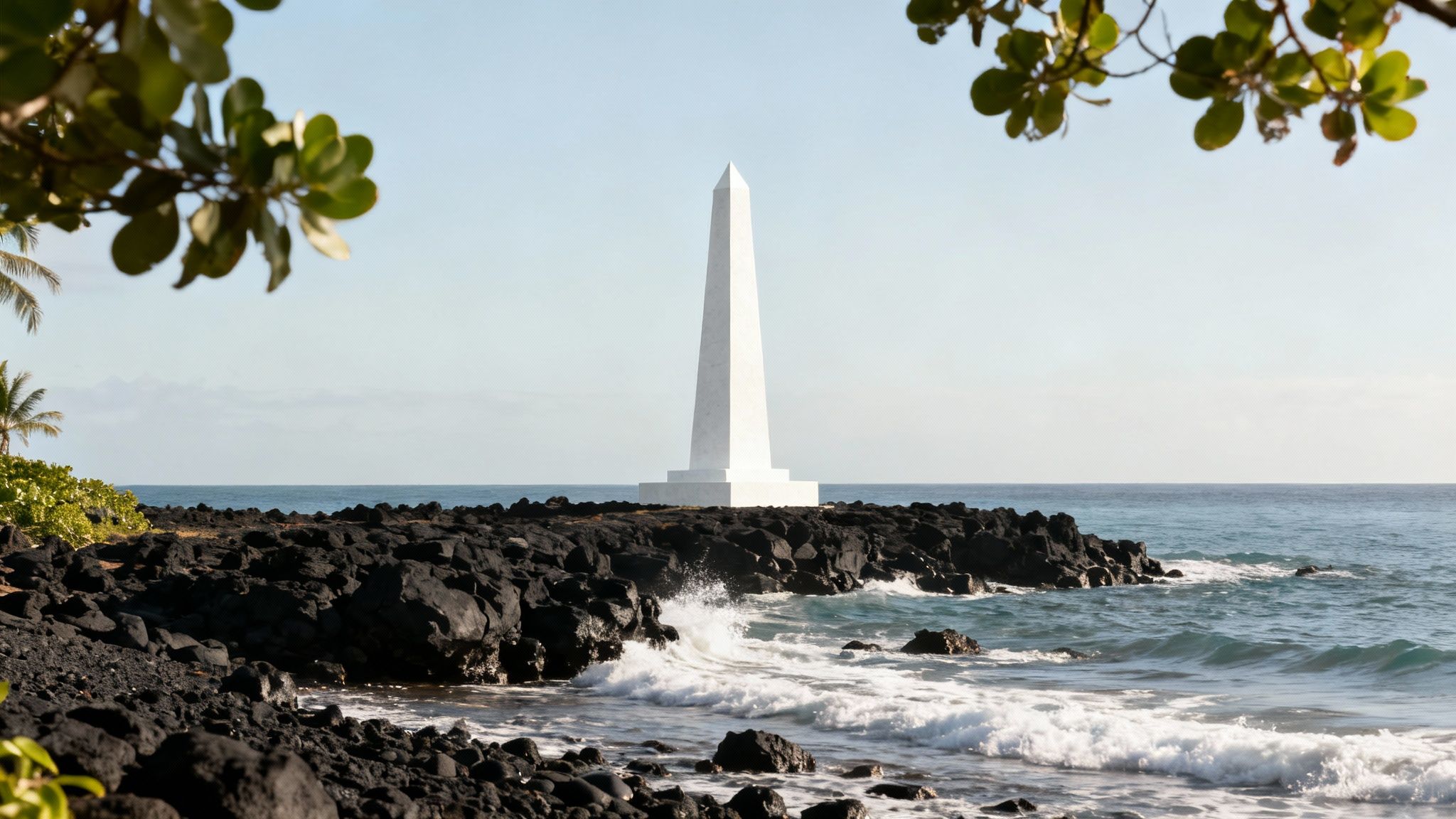 The white Captain Cook Monument stands against the lush green cliffs of Kealakekua Bay.