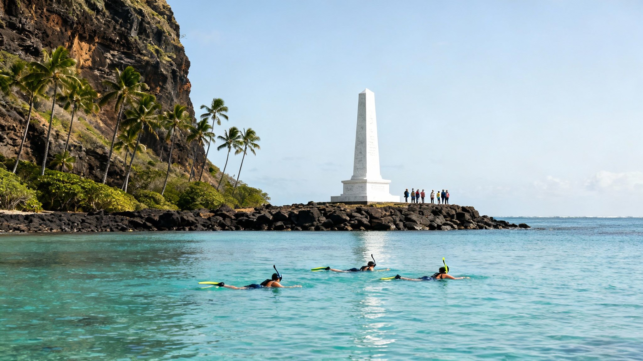 Snorkelers swim in clear blue ocean near a white monument and a palm-lined cliff.