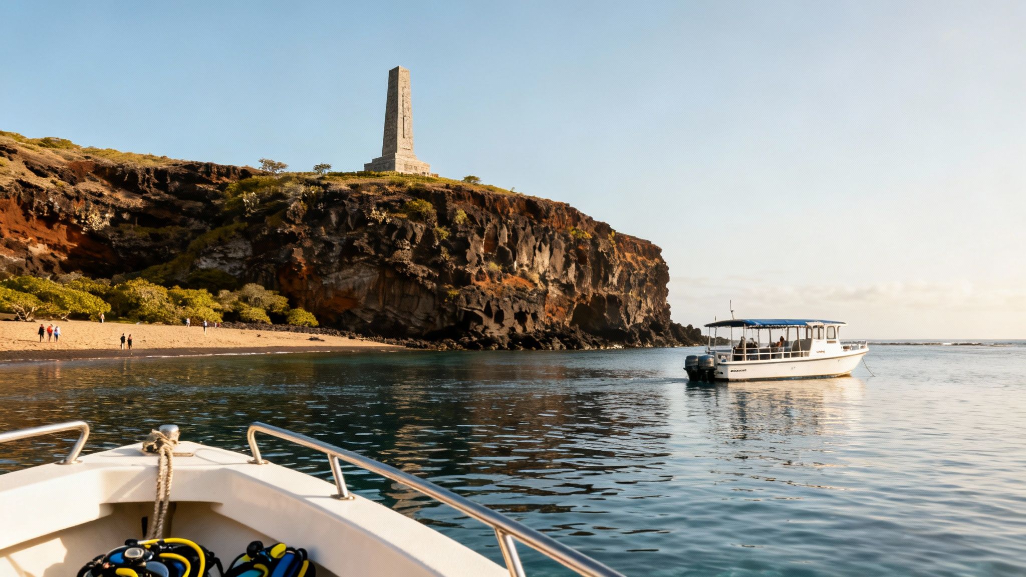 Boats in a sunny bay with a sandy beach, cliff, and monument under a clear sky.