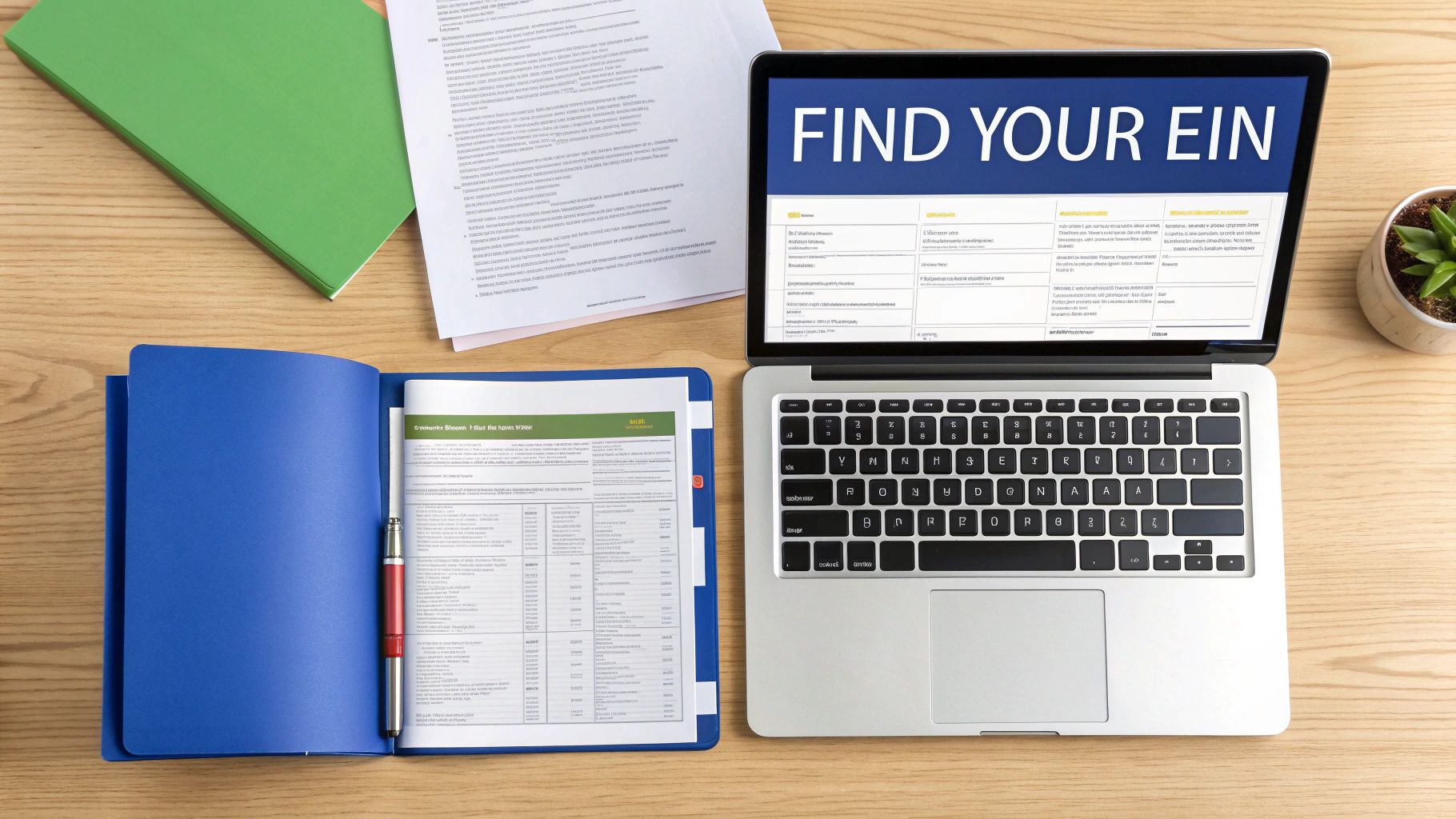 Overhead view of a workspace with a laptop displaying 'FIND YOUR EIN' and office documents.