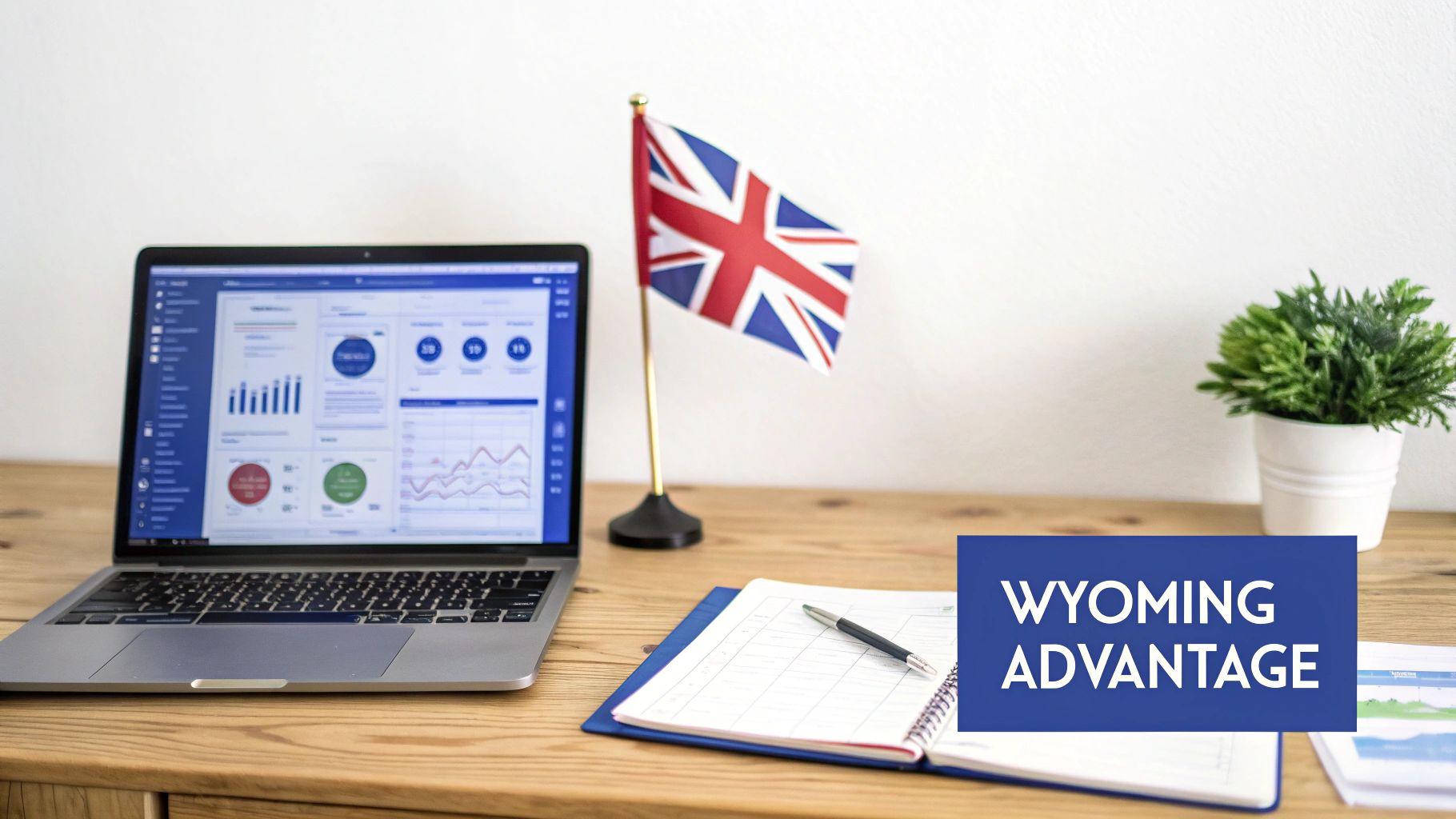 A business desk with a laptop showing charts, a UK flag, a notebook, and a plant.