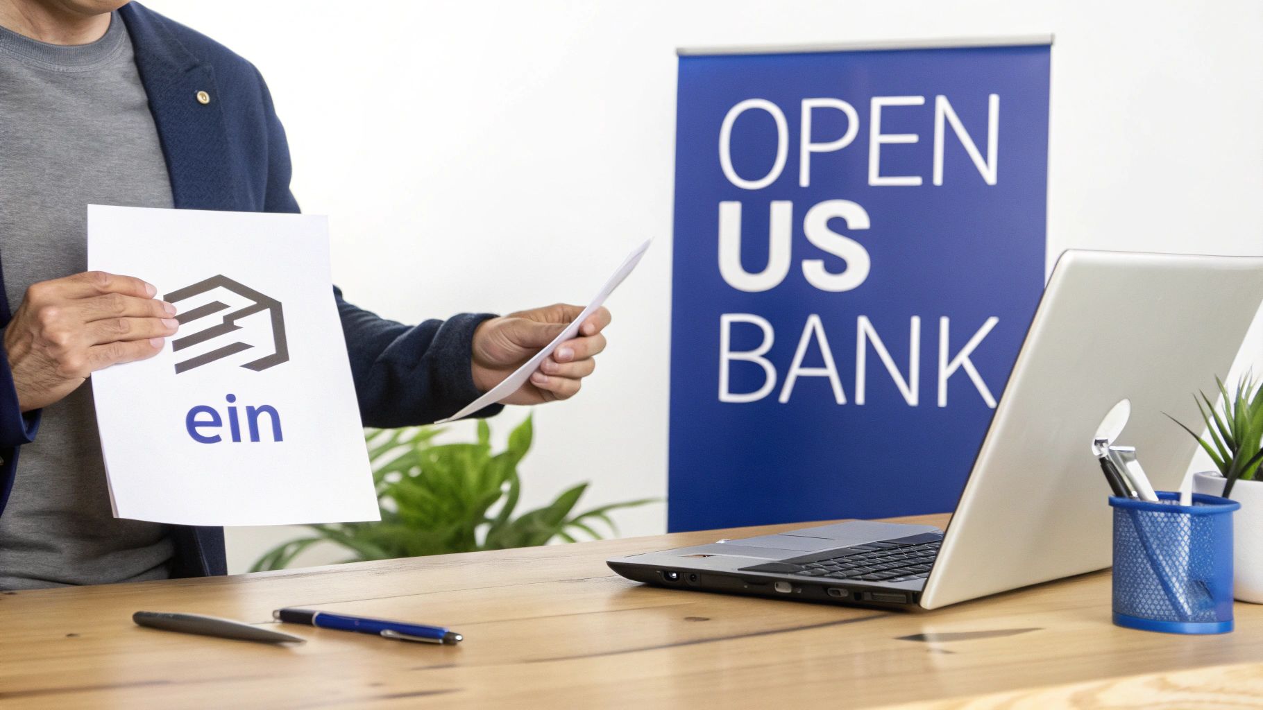 A person holding a document with 'ein' logo, with 'Open US Bank' banner and a laptop on desk.