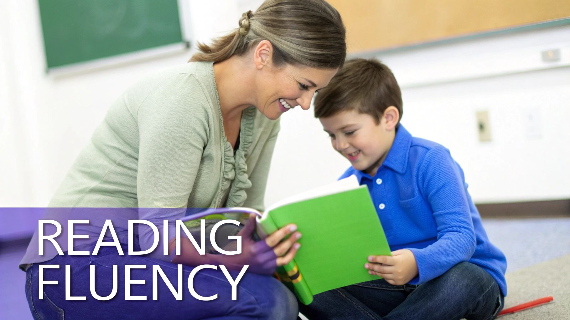 A smiling teacher helps a young student read a green book, focusing on reading fluency.