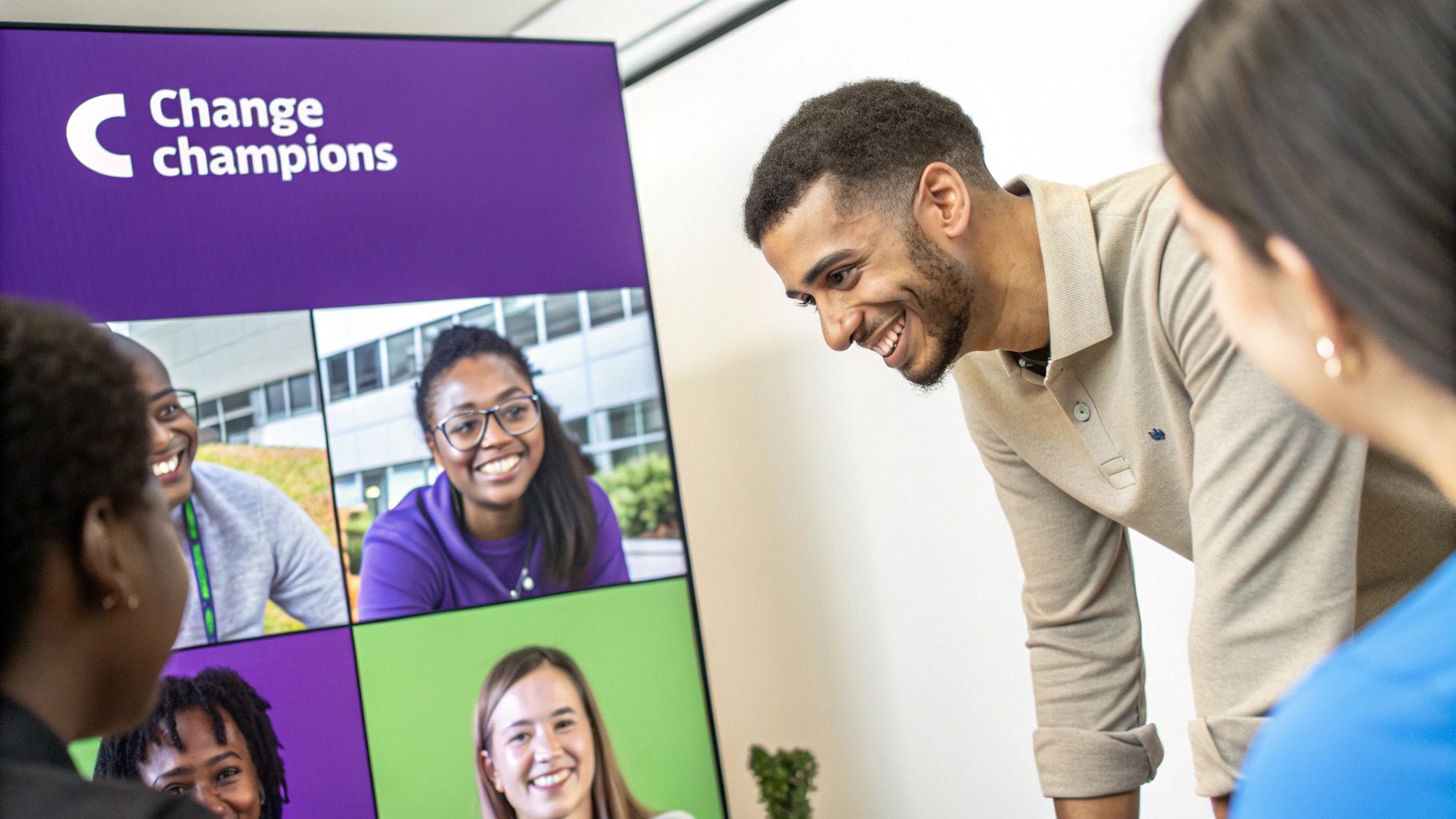 Diverse group smiling and engaging in a virtual meeting about 'Change Champions' on a large screen.
