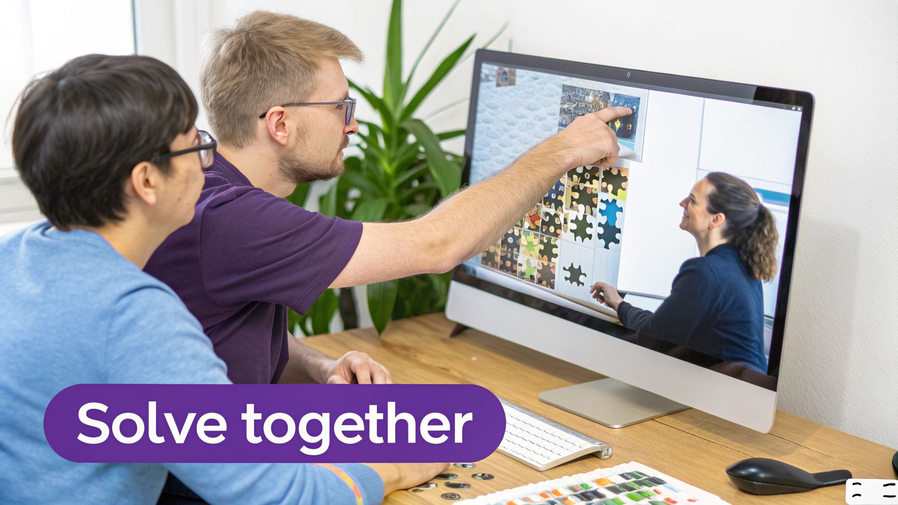 Two colleagues collaborate at a computer, playing a digital puzzle game with a 'Solve together' banner.