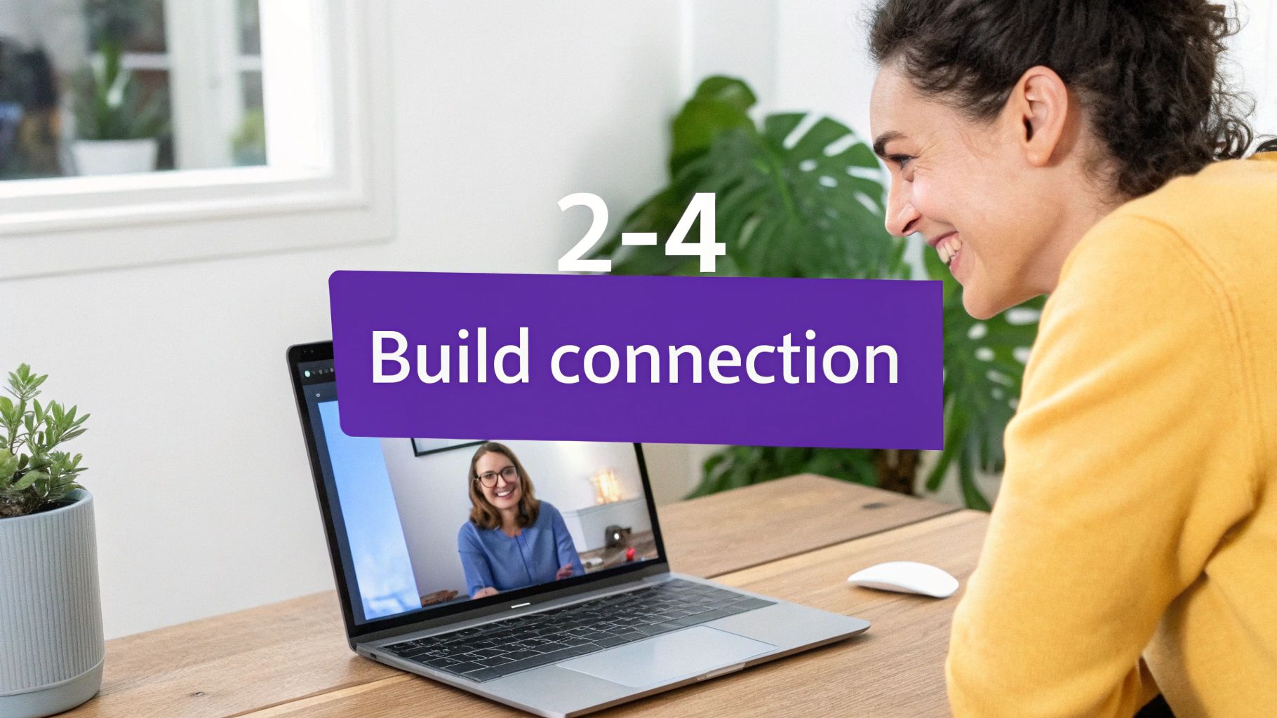 A smiling woman engages in a video call on her laptop, building connection with another person.