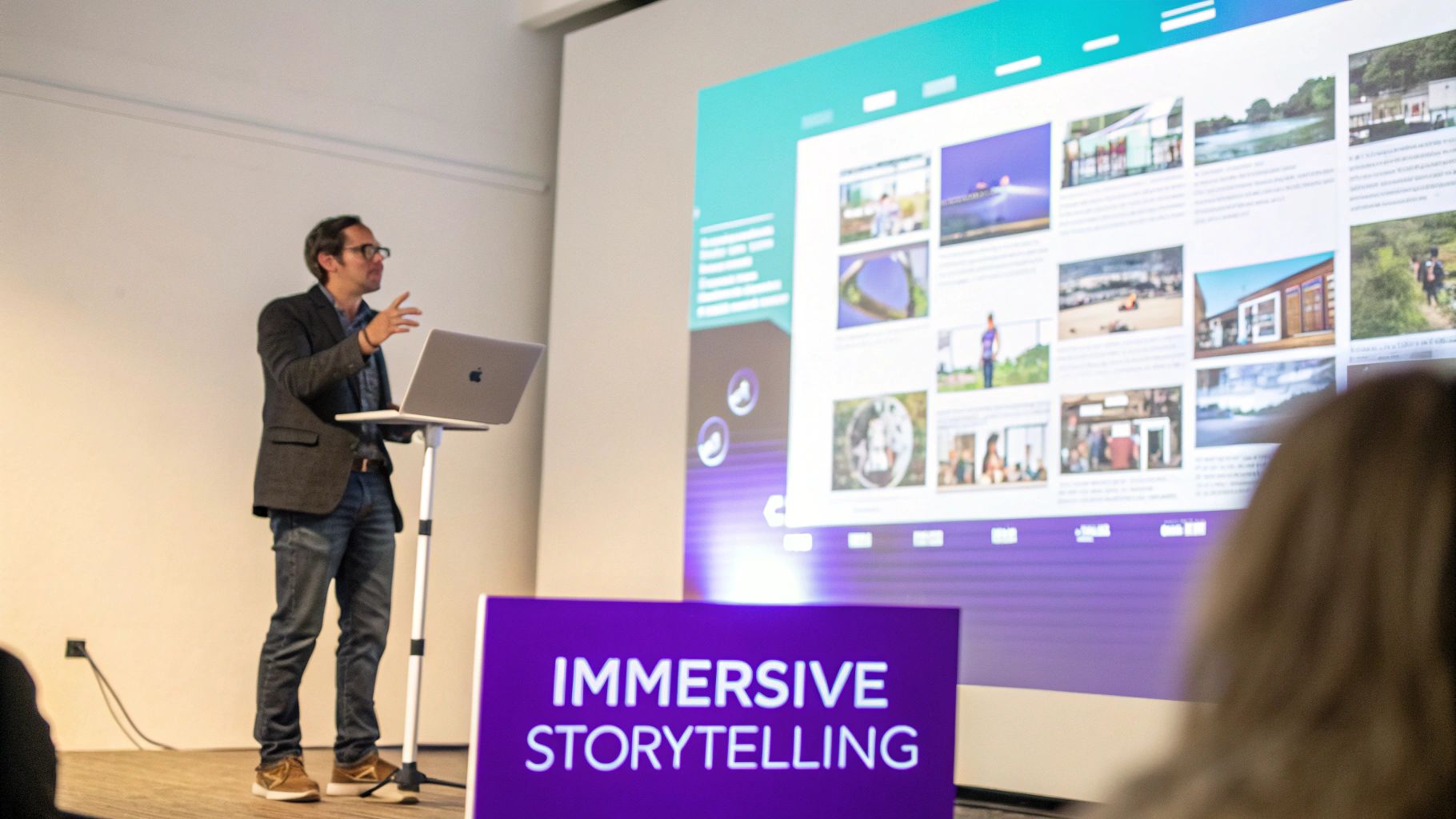 Man presenting "Immersive Storytelling" concepts with a laptop and a large visual display.