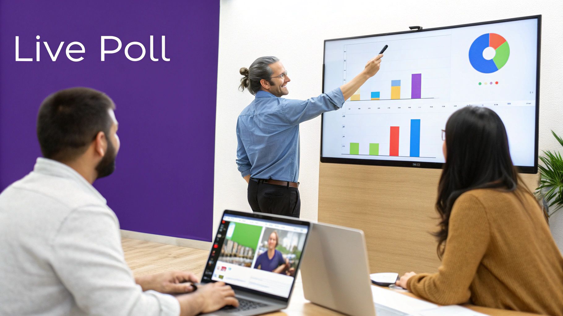 A man points to data charts on a large screen during an interactive presentation for attendees.