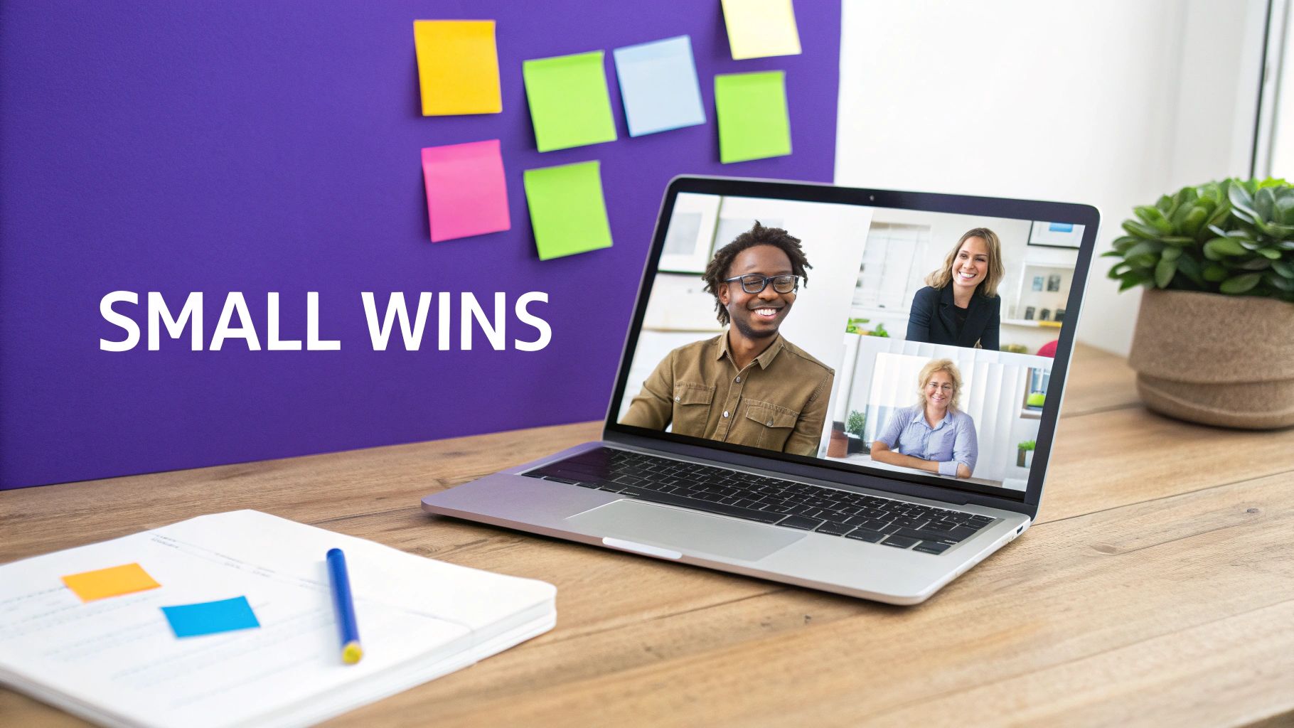 A diverse team in a virtual meeting on a laptop, with a 'SMALL WINS' board visible.