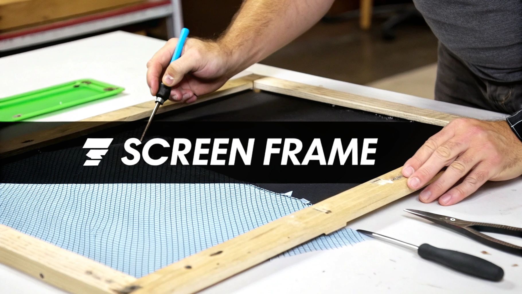 Hands installing a light blue mesh onto a wooden screen frame using a small blue tool.