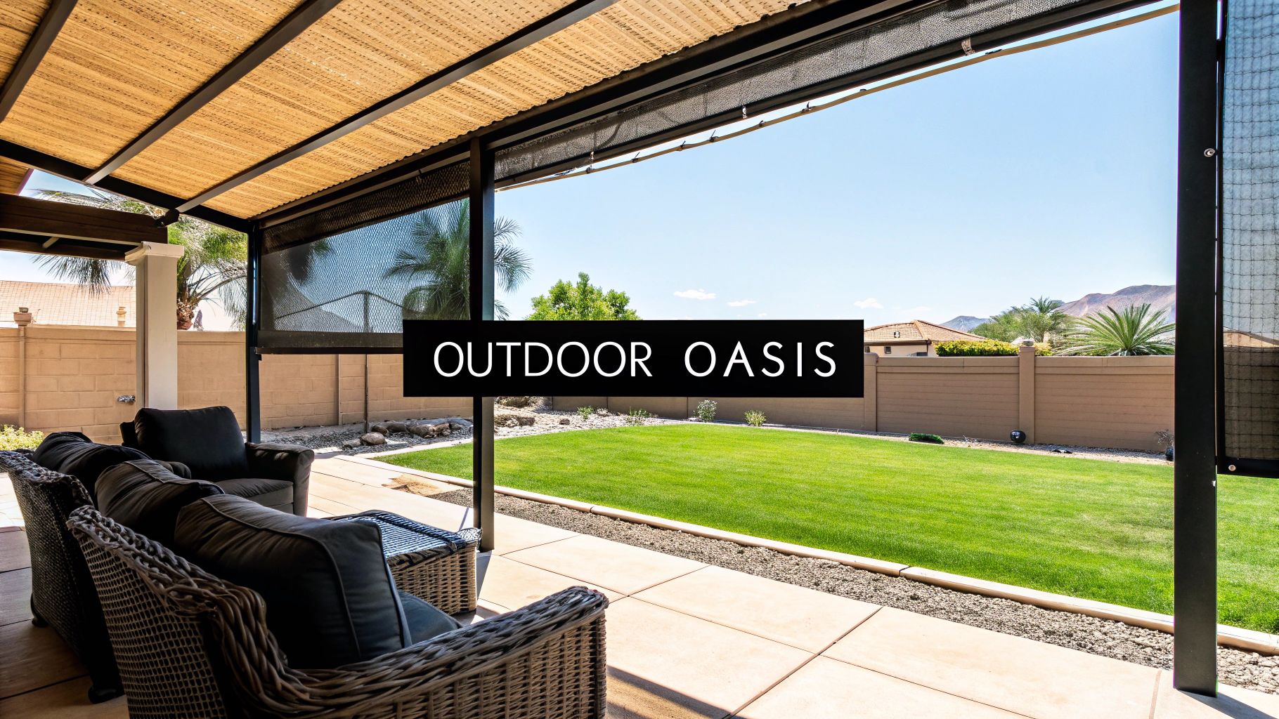 A comfortable outdoor patio with wicker furniture, sun screens, a green lawn, and distant mountains.