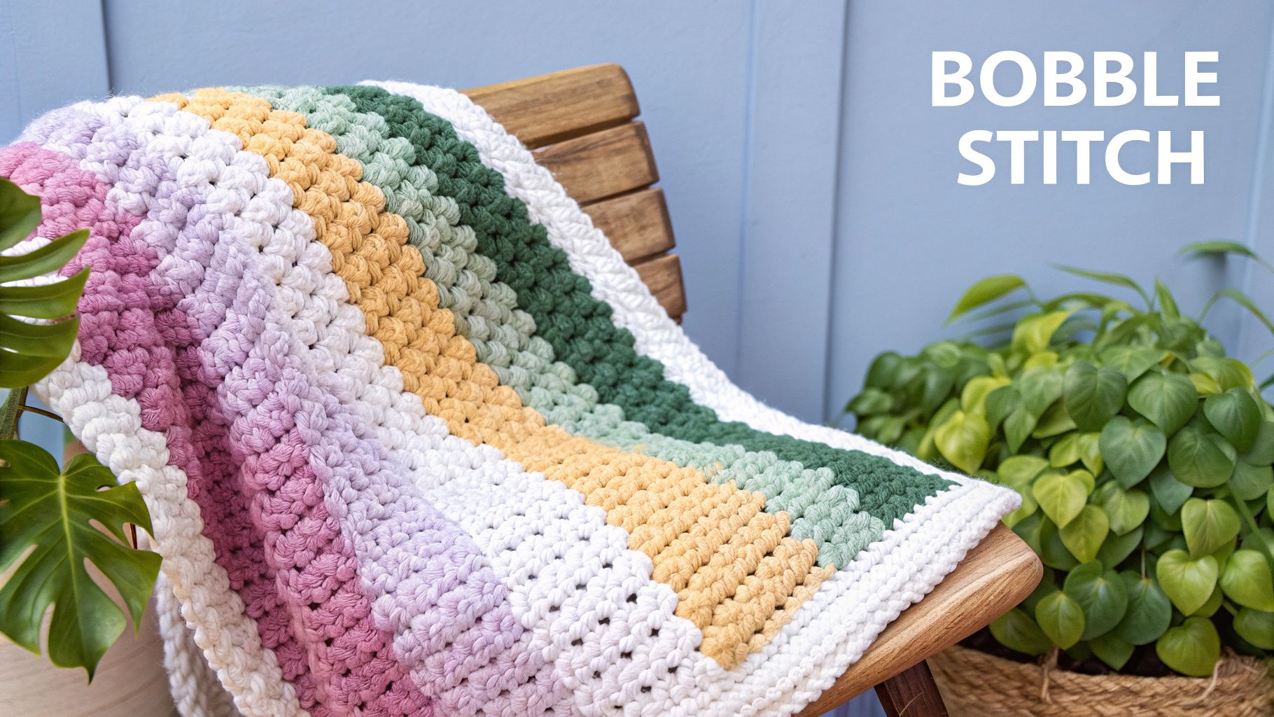 A close-up of a crocheted fabric featuring rows of textured bobble stitches in a soft, neutral-colored yarn.