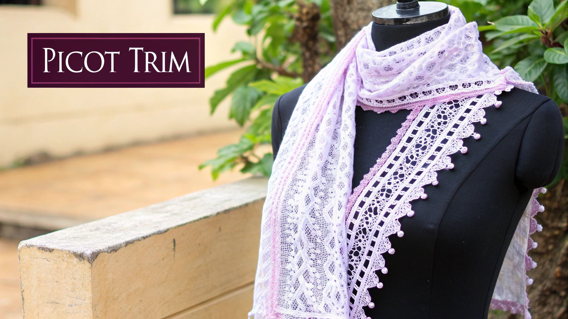 A close-up of a delicate picot edging on a light-colored crochet scarf, showcasing its small, decorative loops.