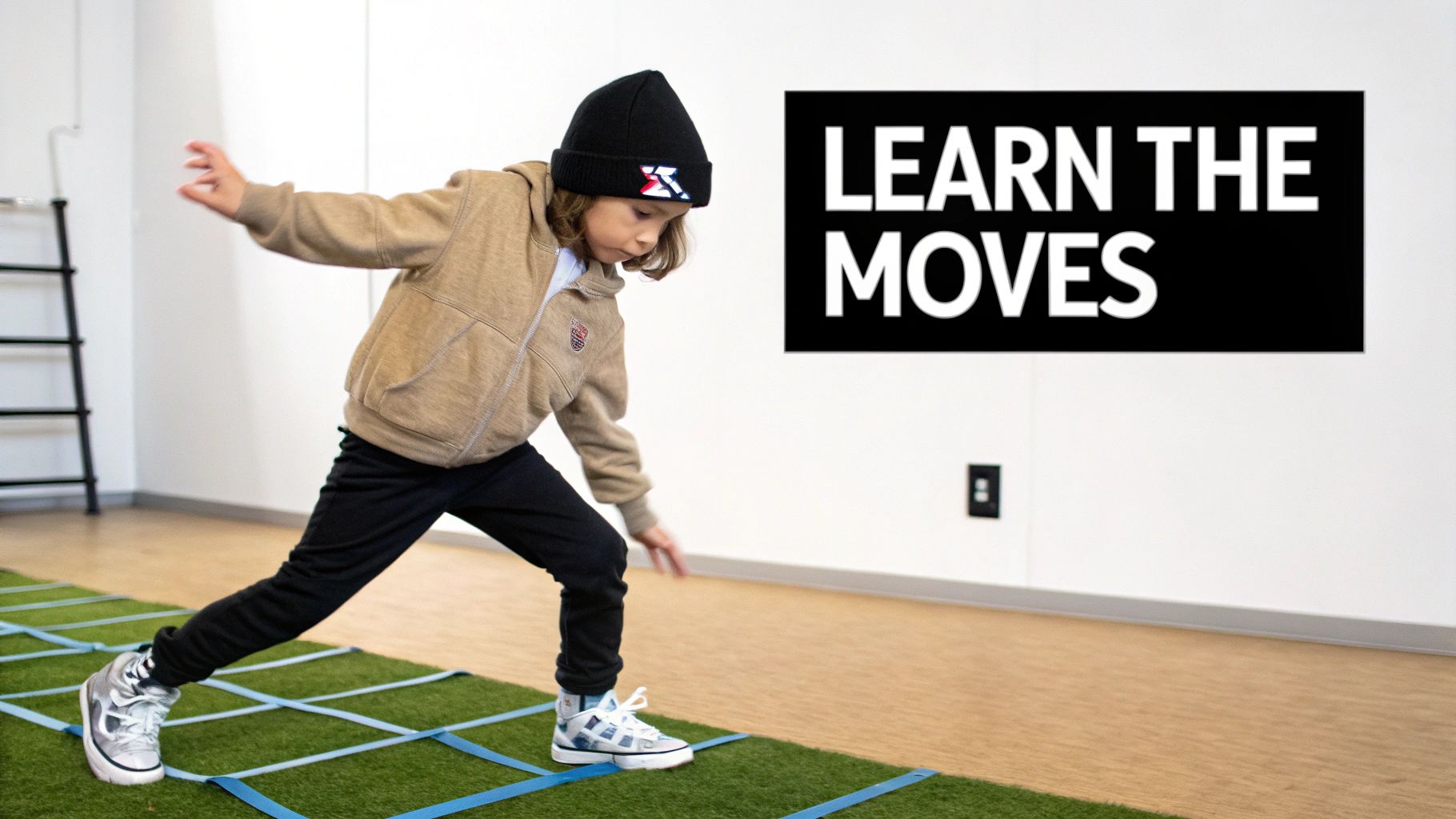 A focused young child learning hip-hop dance moves on an agility ladder indoors.