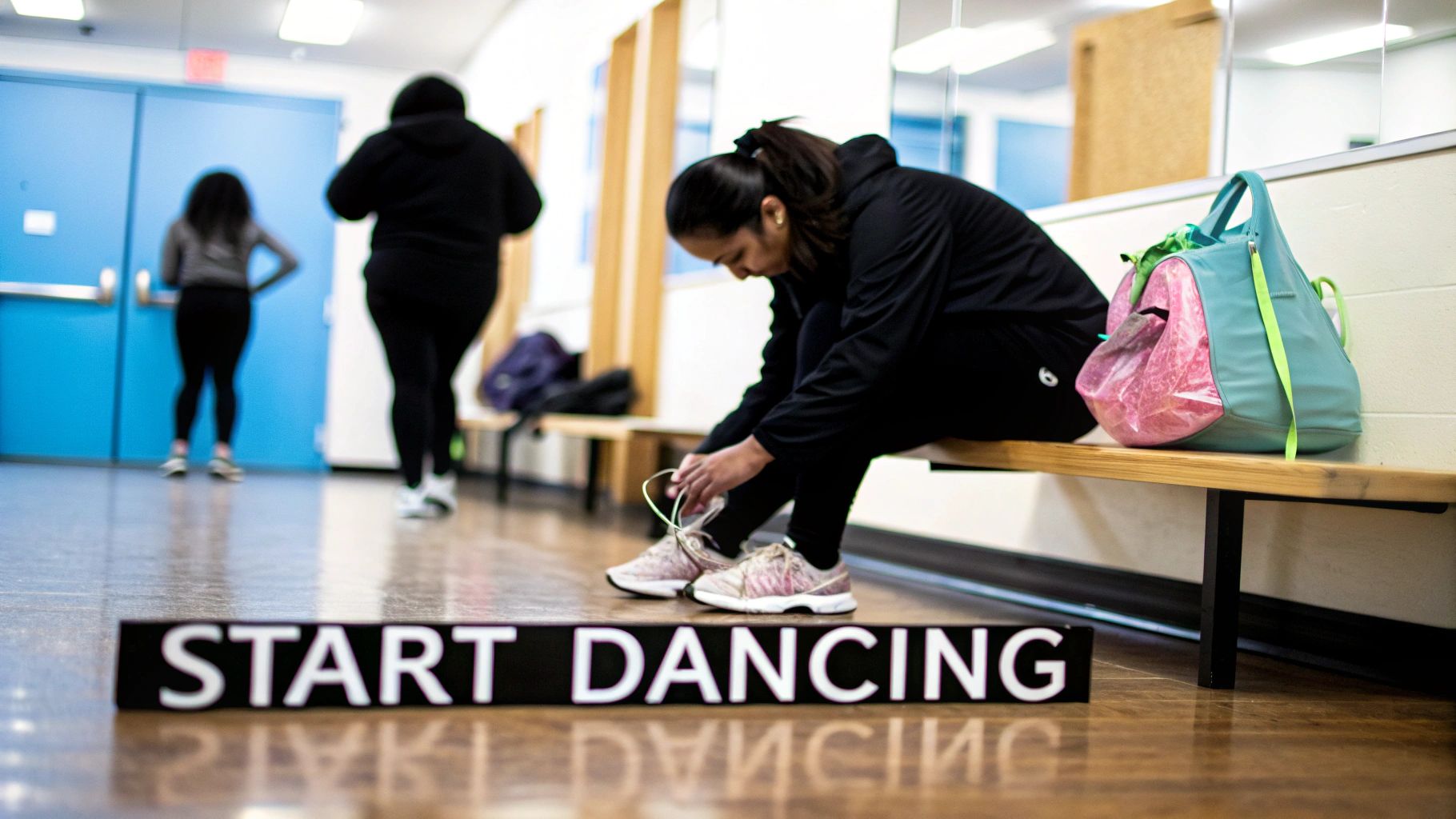A woman ties her shoes on a bench next to a gym bag, preparing to start dancing.