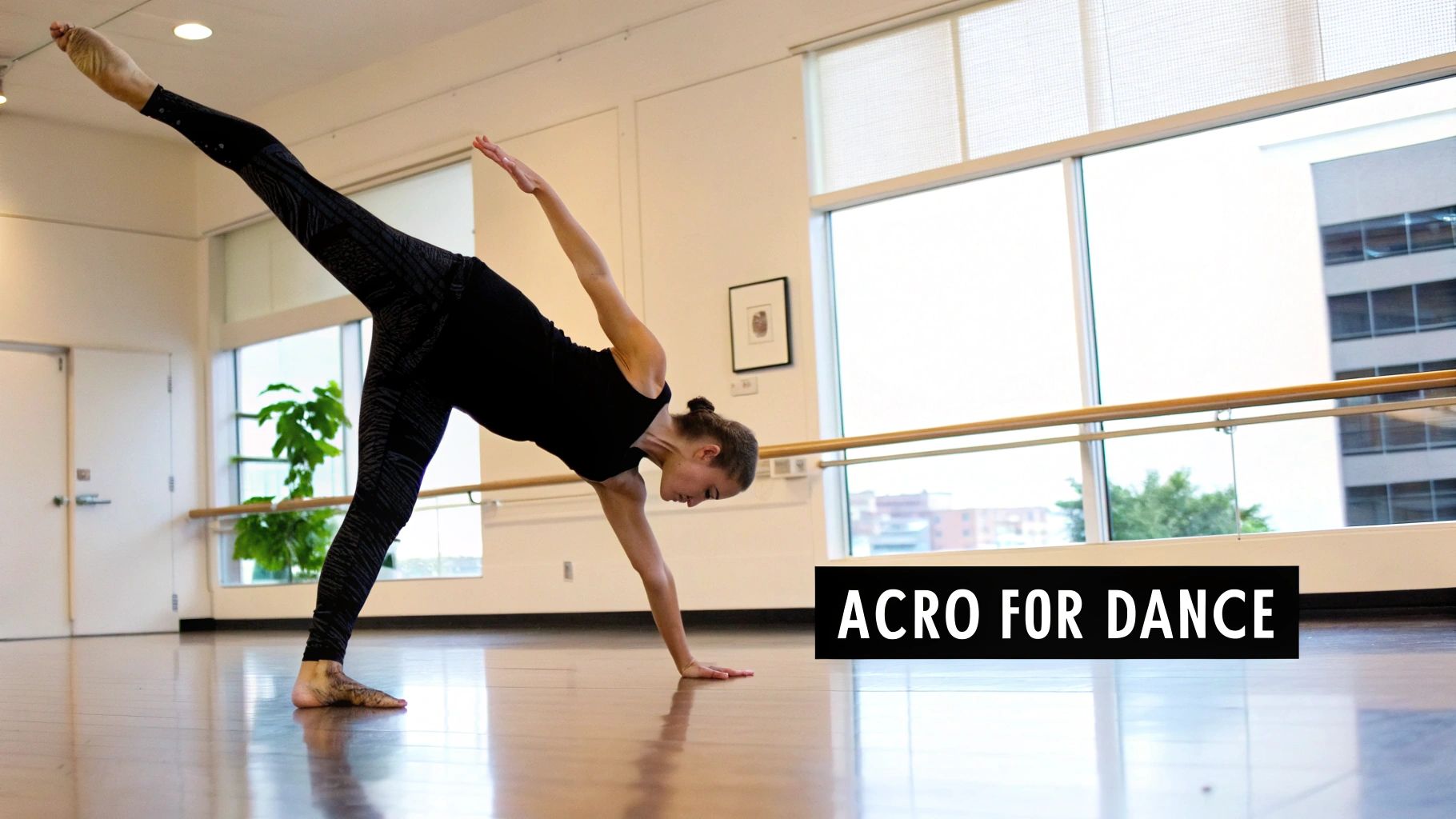 A female dancer performs an acro balance with one leg extended high in a bright studio.