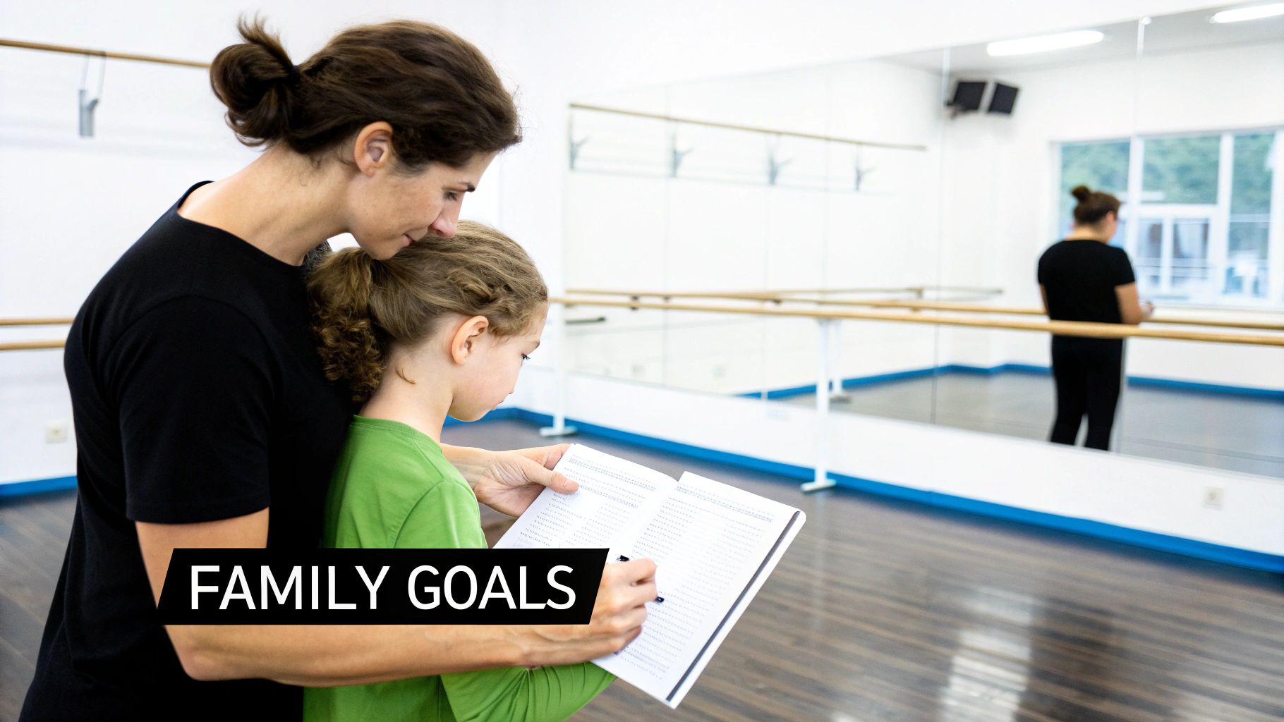 A mother and daughter review notes together in a dance studio with a ballet barre and mirrors.