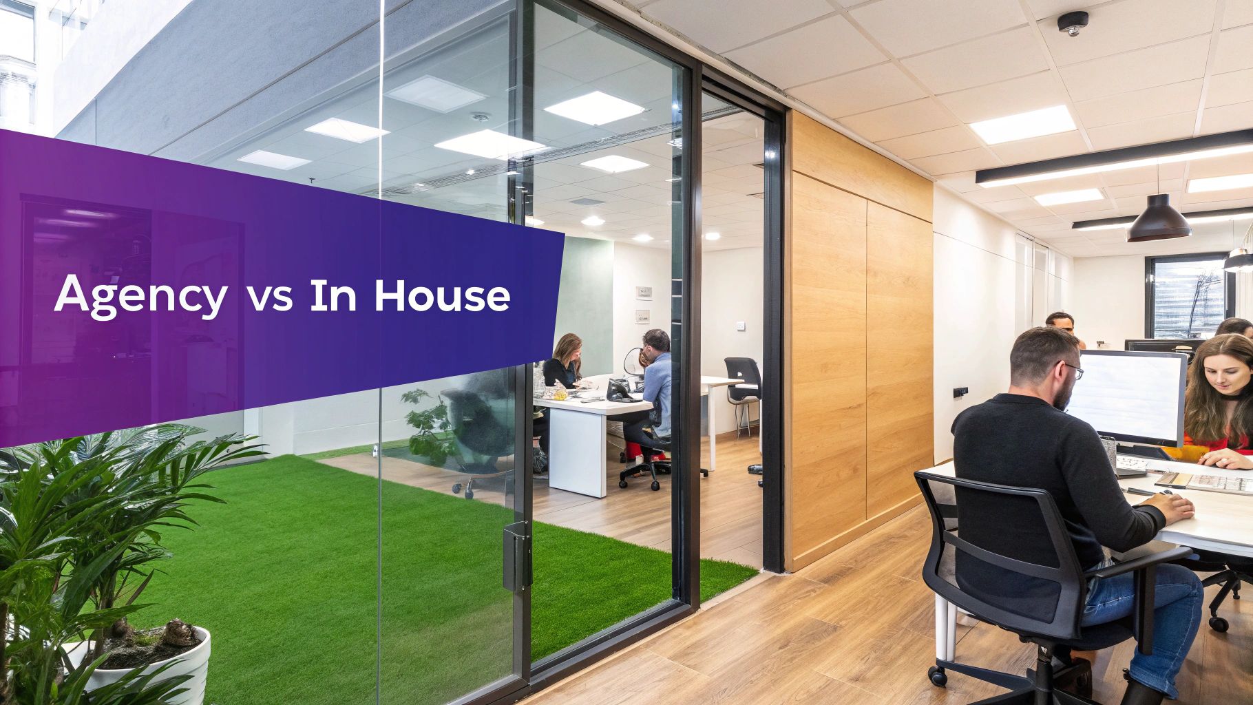 Modern office interior with glass partitions, artificial turf, and people working at desks, featuring an 'Agency vs In House' banner.