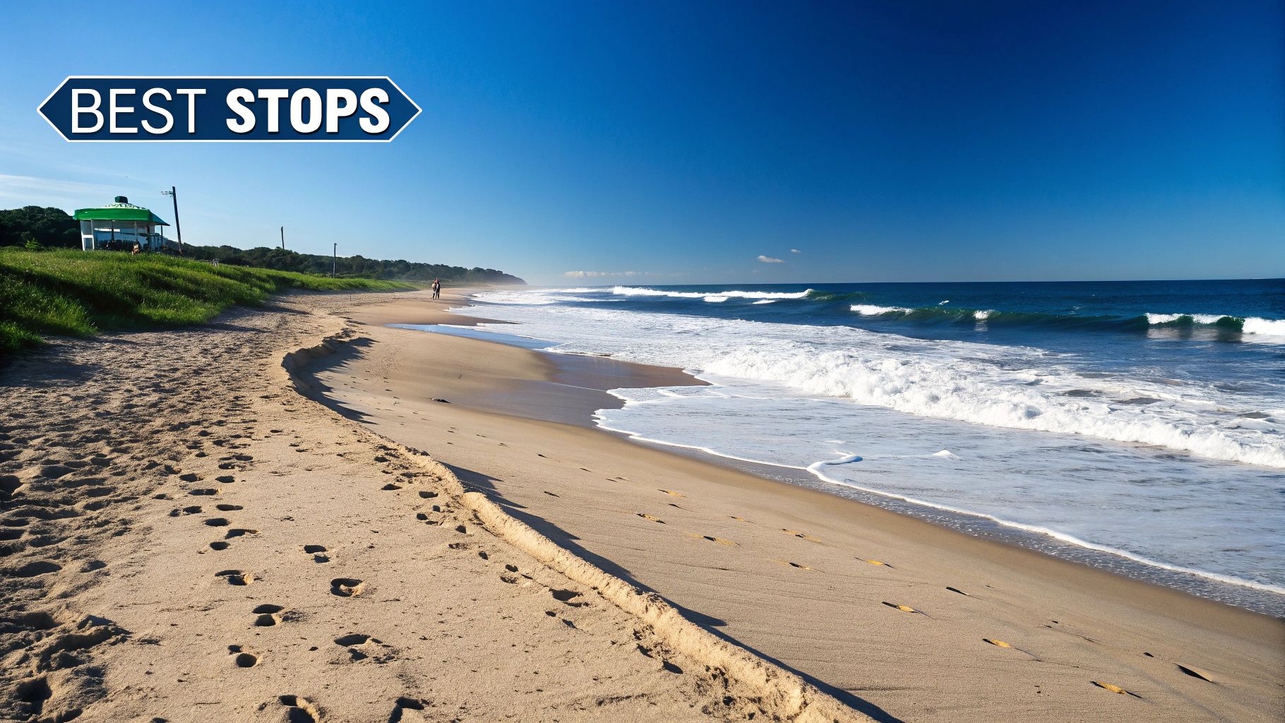 A scenic sunny beach with waves, footprints in sand, and a 'BEST STOPS' sign under a clear blue sky.