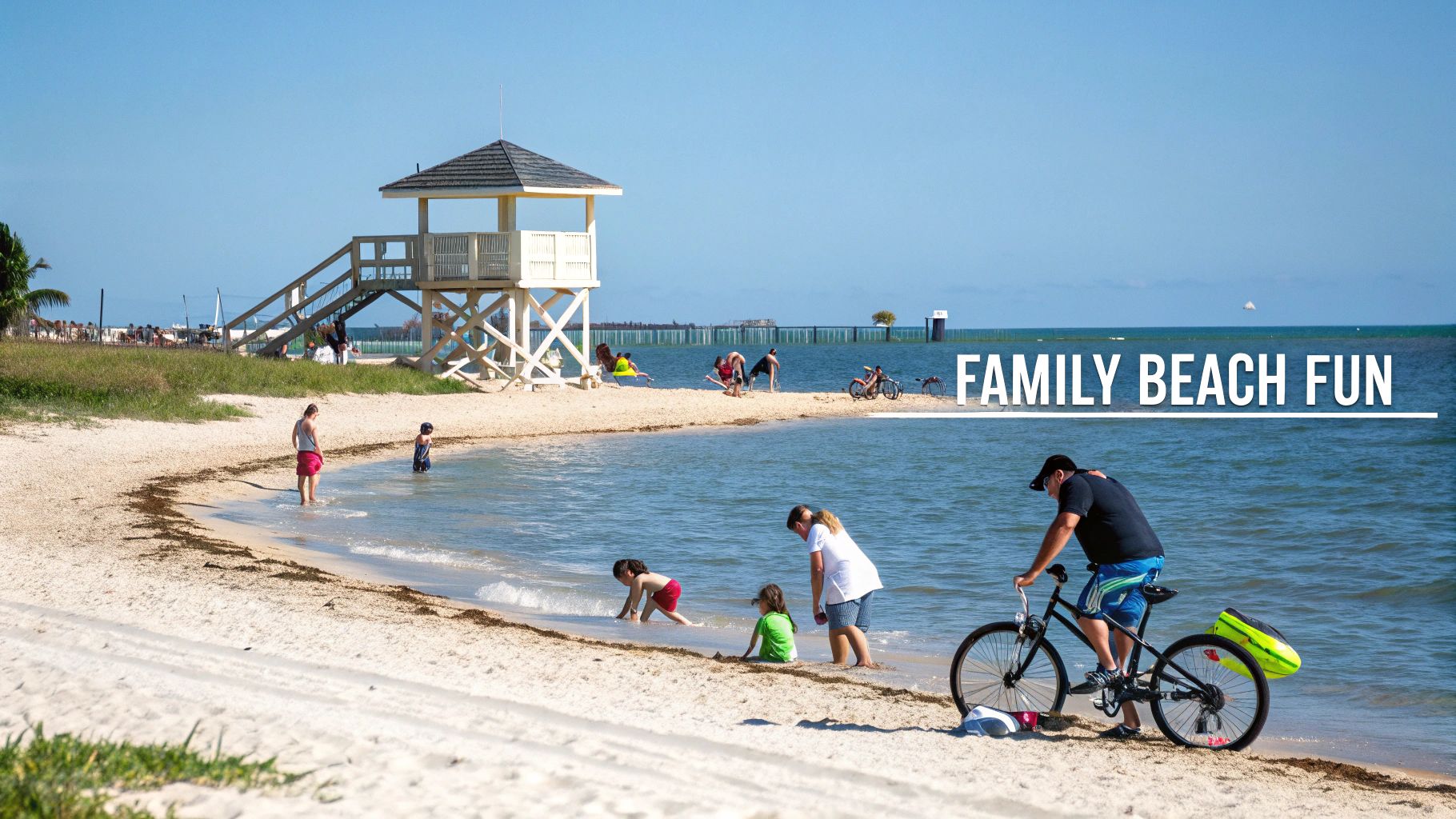 Families enjoy a sunny day at a beautiful beach with a lifeguard tower and calm water.