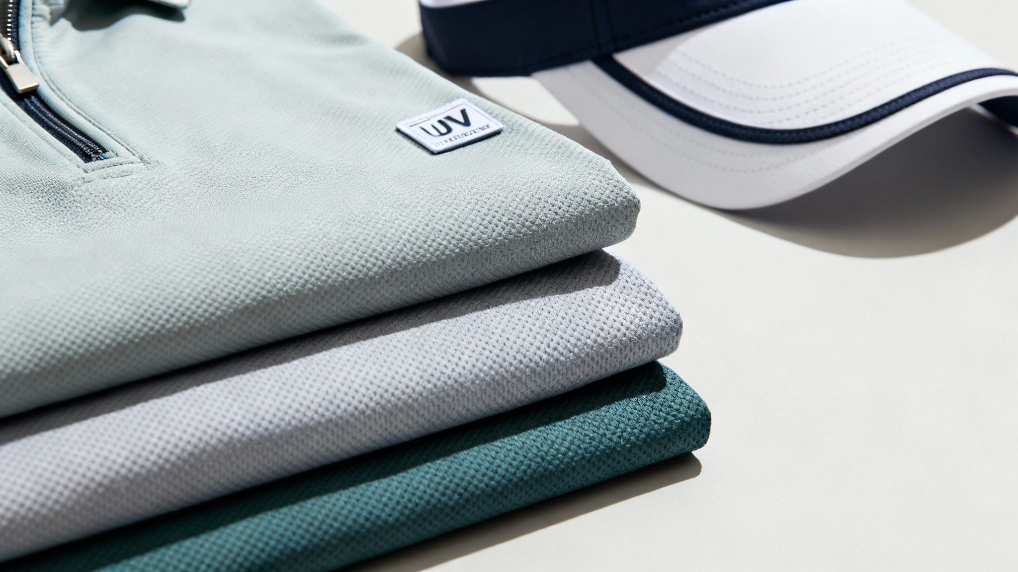 A person inspecting the high-quality fabric of a custom golf polo shirt