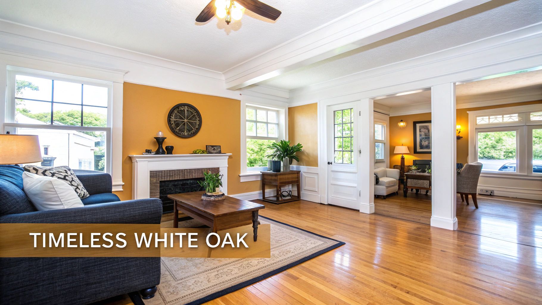 A bright living room featuring white oak hardwood floors, yellow walls, a blue sofa, and a fireplace.