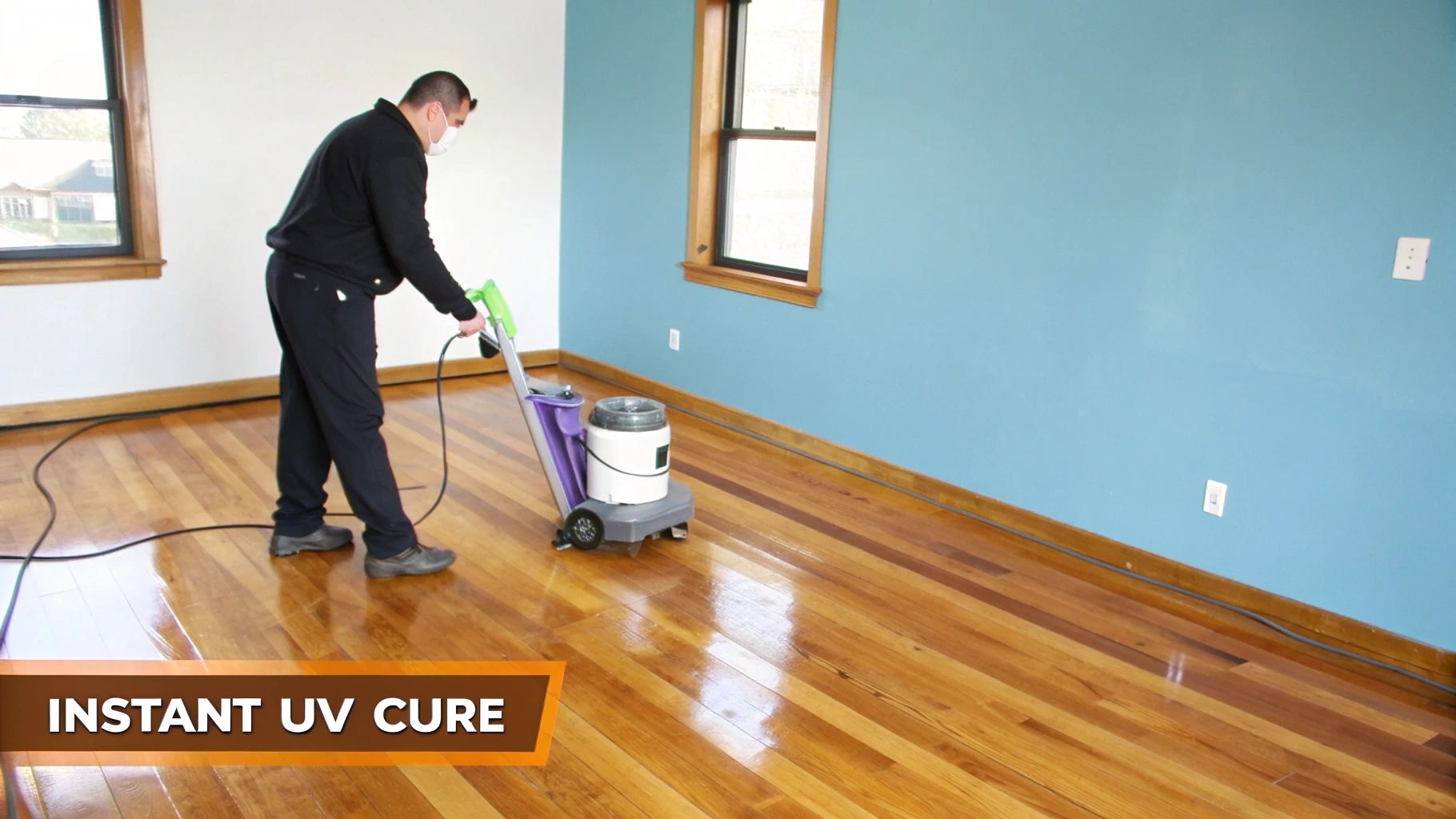 A person applies an instant UV cure finish to a shiny red oak hardwood floor.