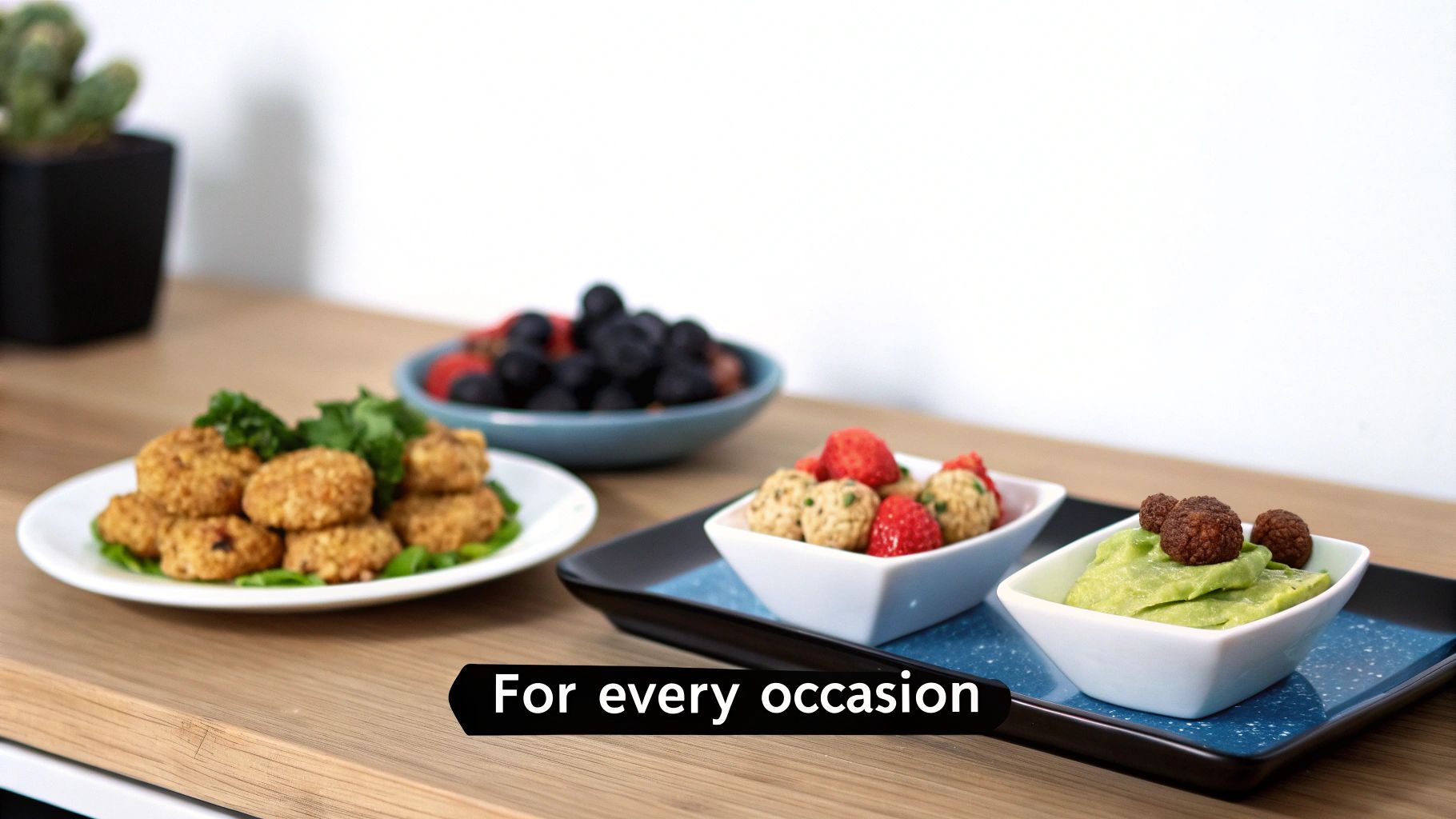 An inviting spread of gluten-free appetizers: savory nuggets, fruit, energy balls, and guacamole dip.