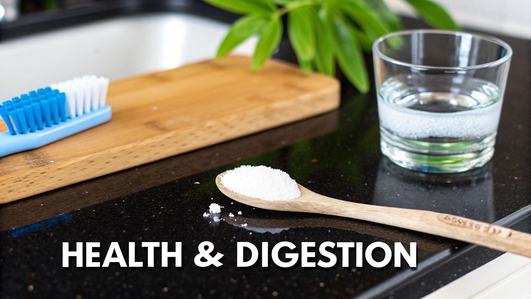 A blue and white toothbrush, a wooden spoon with white powder, and a glass of water on a dark counter.