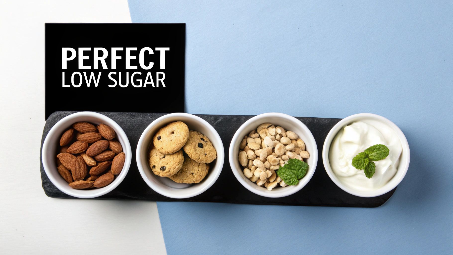 Overhead view of 'PERFECT LOW SUGAR' sign and bowls with almonds, cookies, peanuts, and yogurt.
