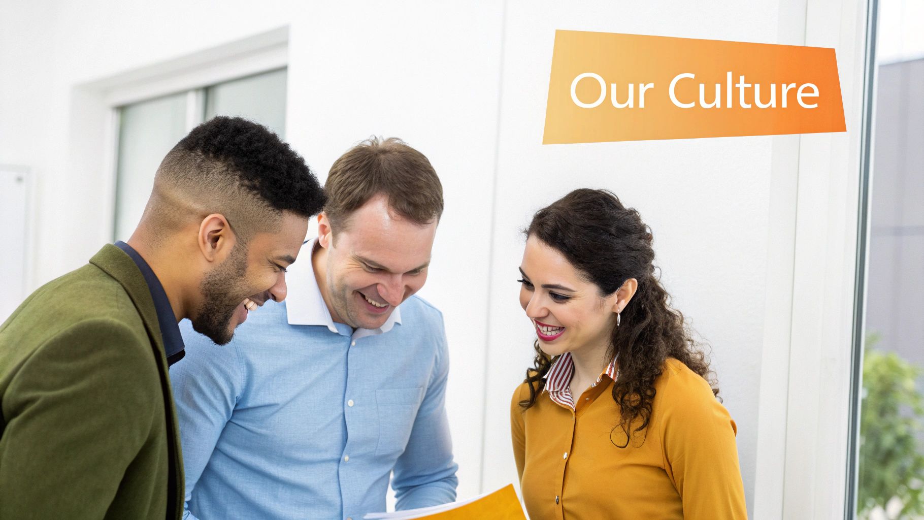 Smiling diverse colleagues review documents together, promoting a positive 'Our Culture' work environment.