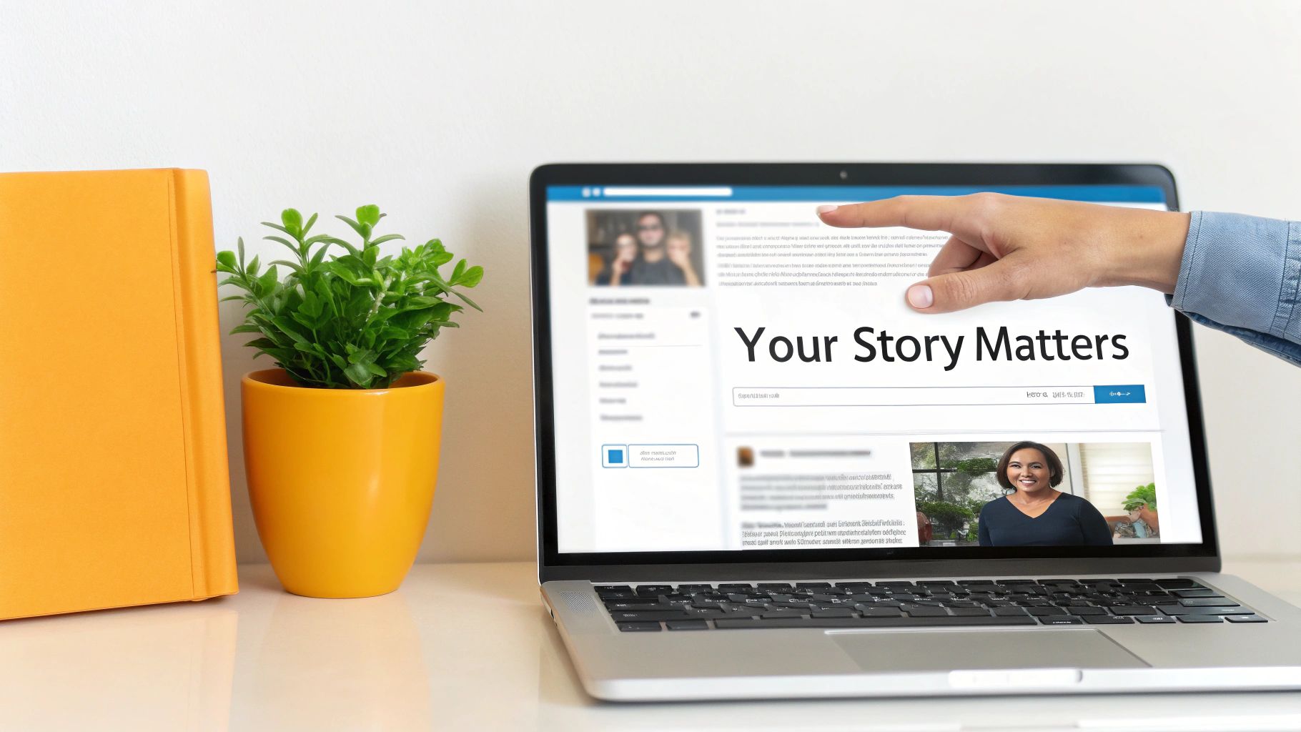 A hand points at a laptop displaying 'Your Story Matters' on a profile, with a book and plant.