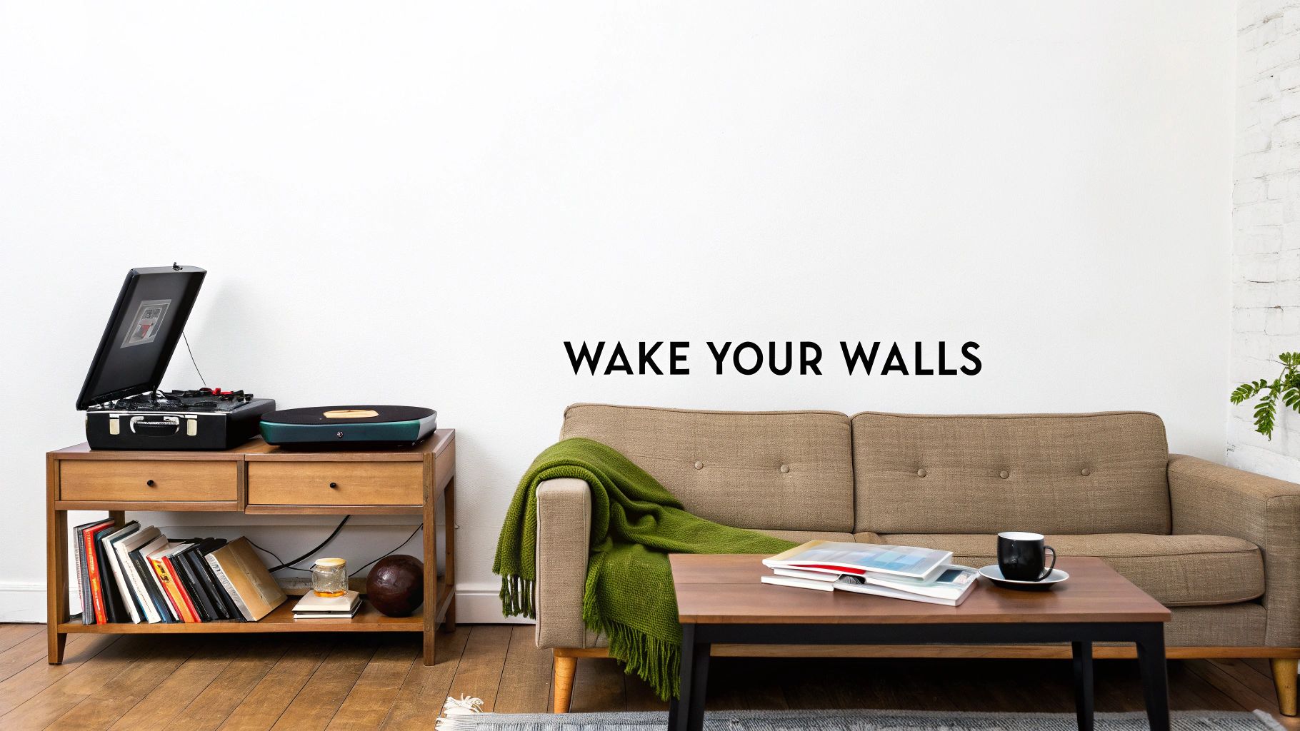 A modern living room features a brown sofa with a green blanket, coffee table, and record player.