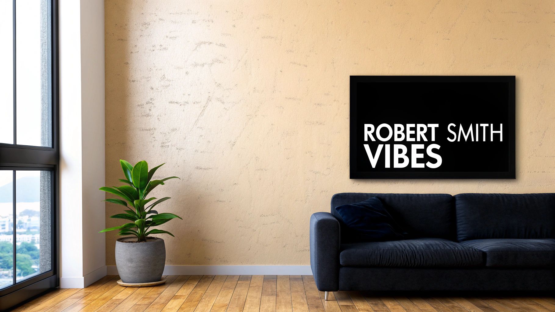 A cozy living room featuring a black sofa, a green plant, and a framed 'Robert Smith Vibes' poster.