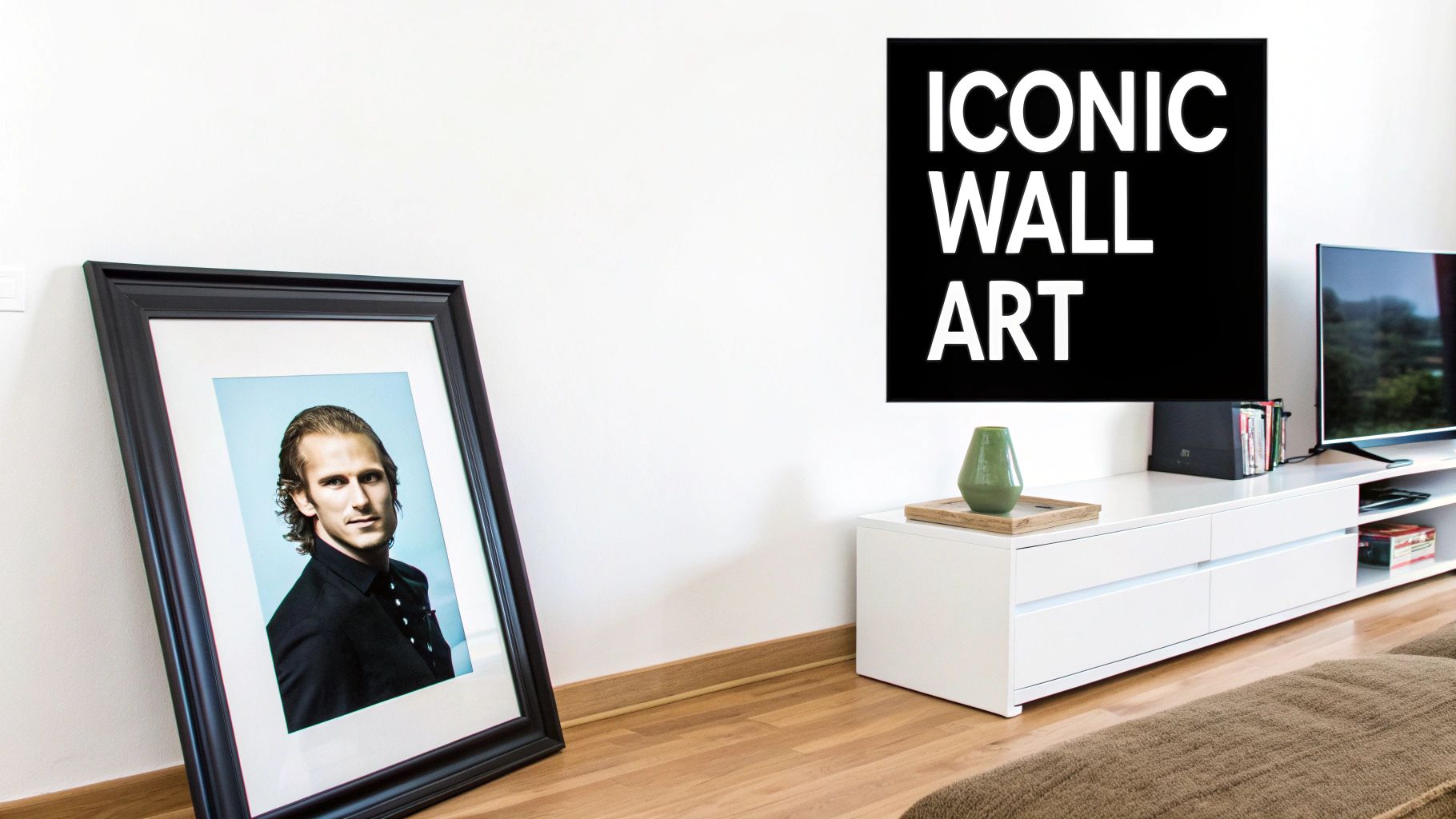 A modern living room with a large framed portrait leaning against a white wall and a media console with a TV.