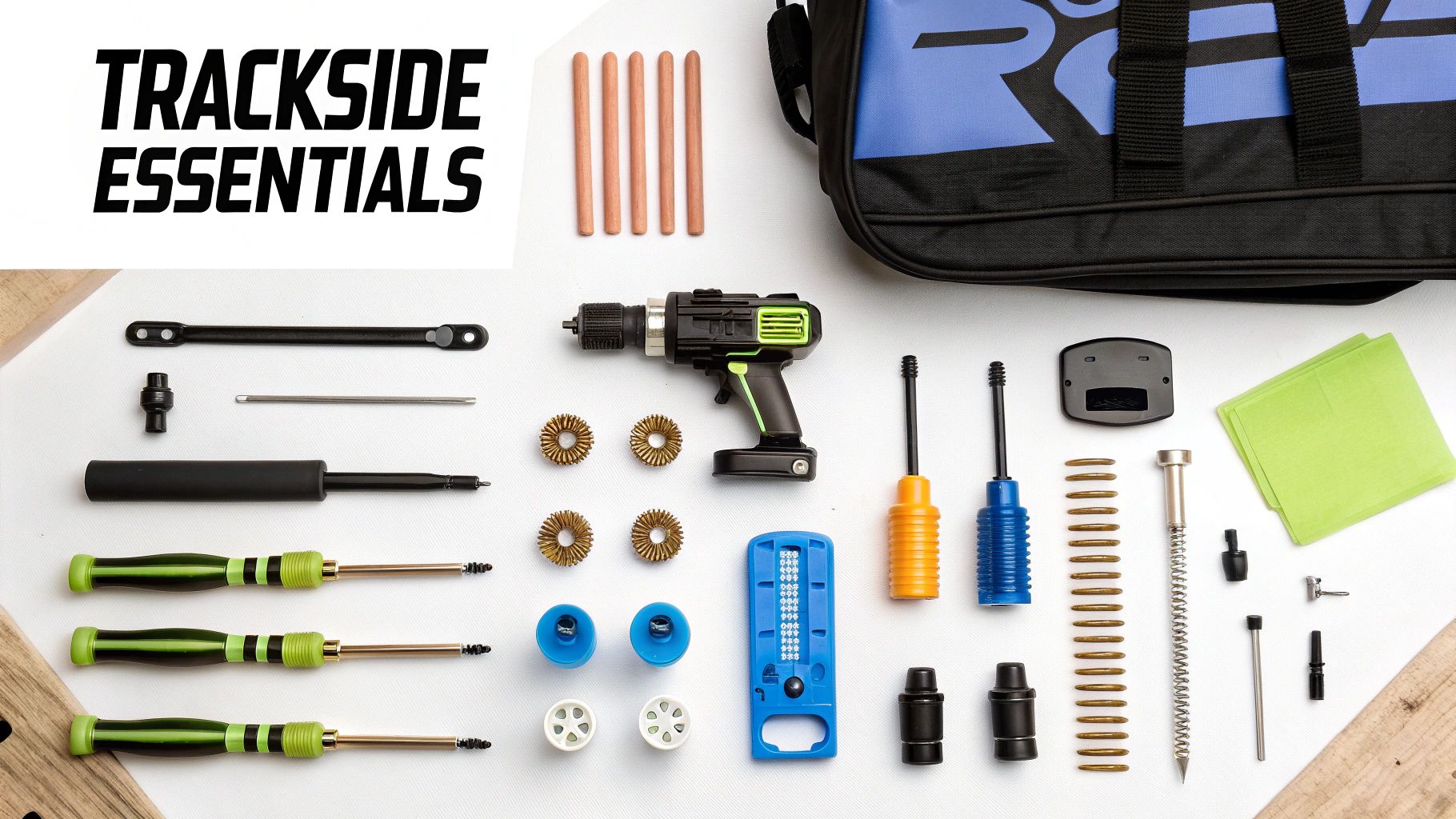 A flat lay of various RC car trackside essential tools and parts, including a drill and screwdrivers.