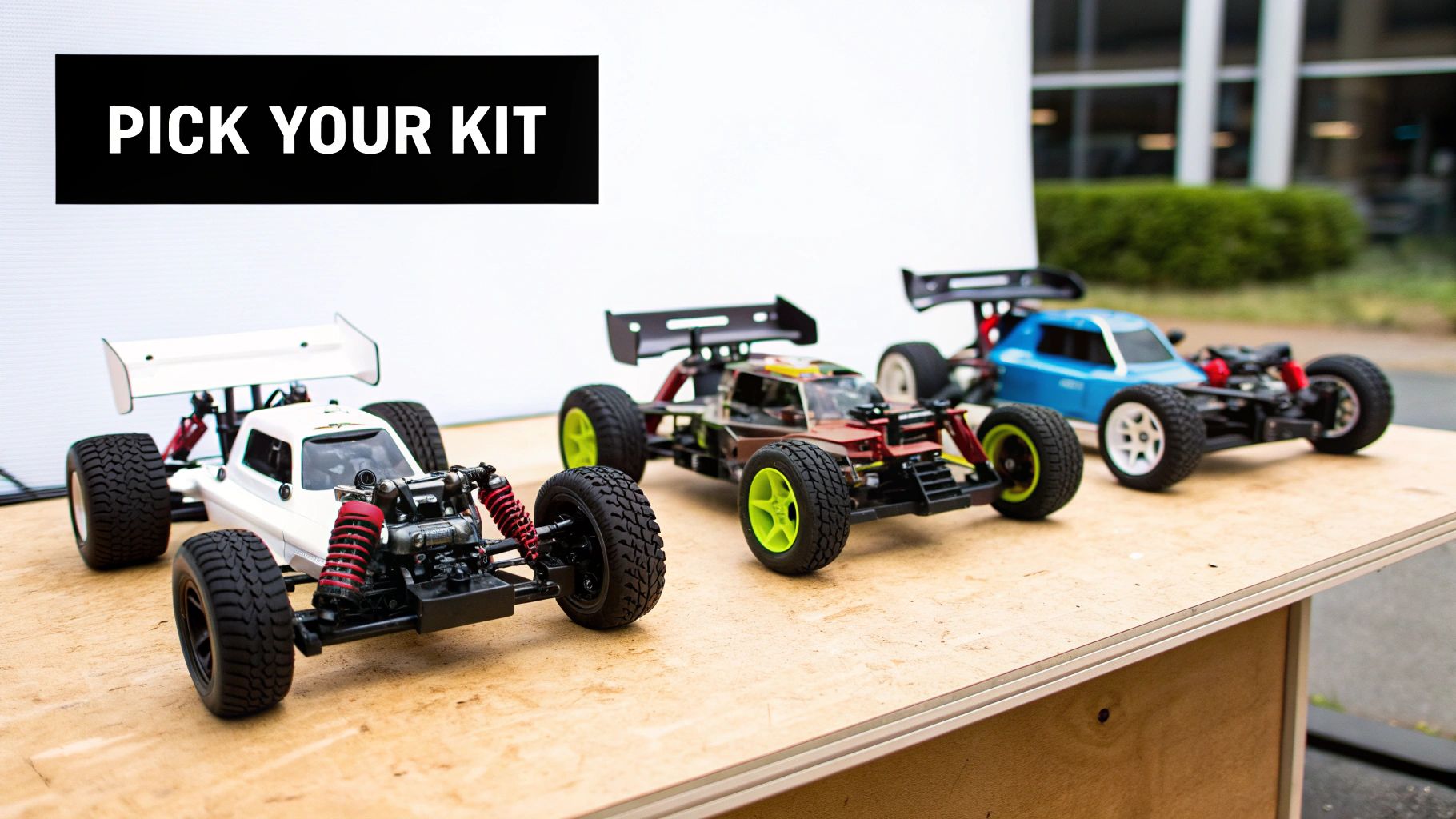 Three colorful remote control car kits displayed on a wooden table with text 'PICK YOUR KIT'.