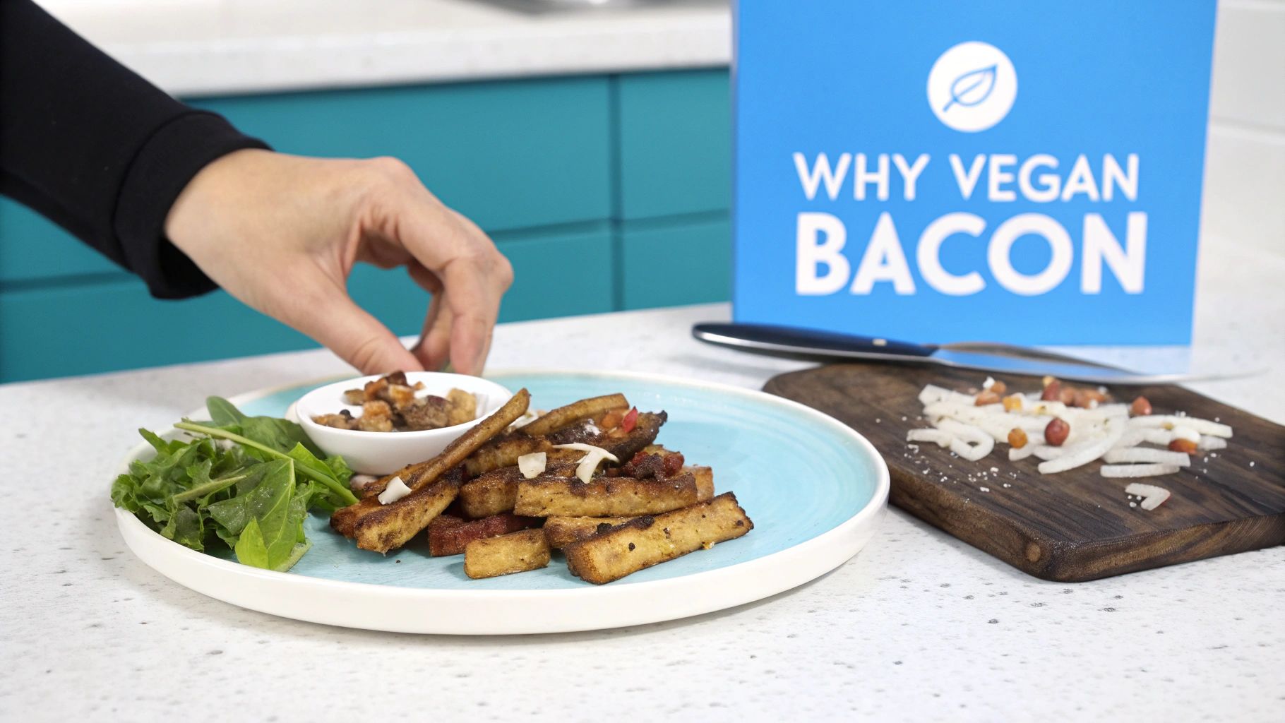 A plate of crispy vegan bacon strips with fresh arugula and a side of nuts, on a kitchen counter.