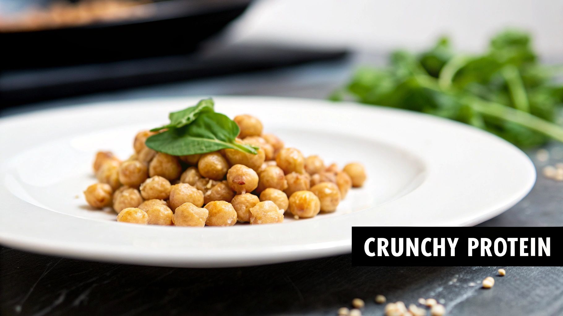 A plate of golden, crunchy roasted chickpeas garnished with a fresh green leaf, promoting healthy protein.