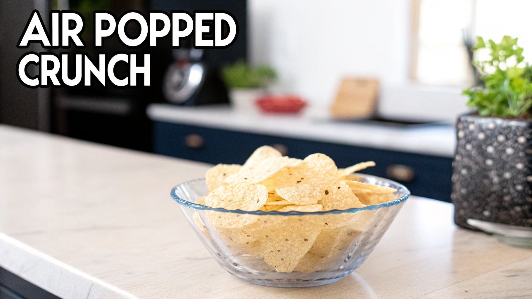 A clear bowl filled with air-popped tortilla chips sits on a white kitchen counter, with a blurred kitchen background.