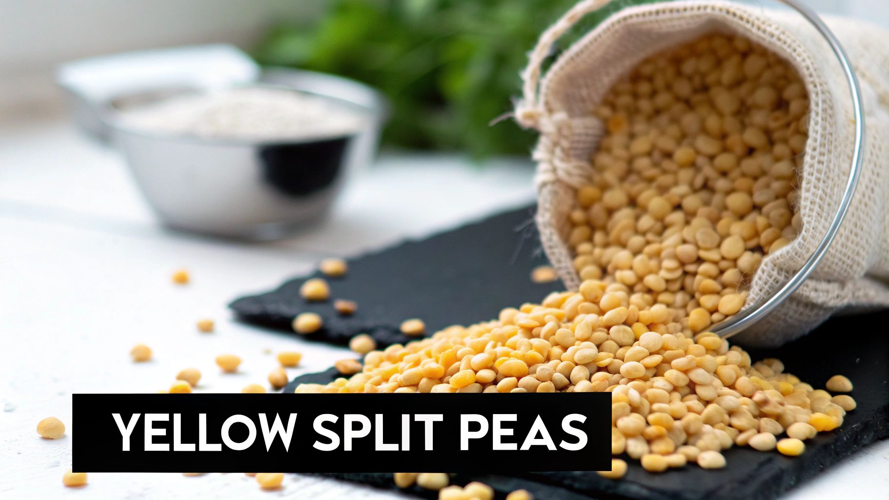 Yellow split peas spilling from a hessian bag onto a black slate surface, with a measuring cup in the background.