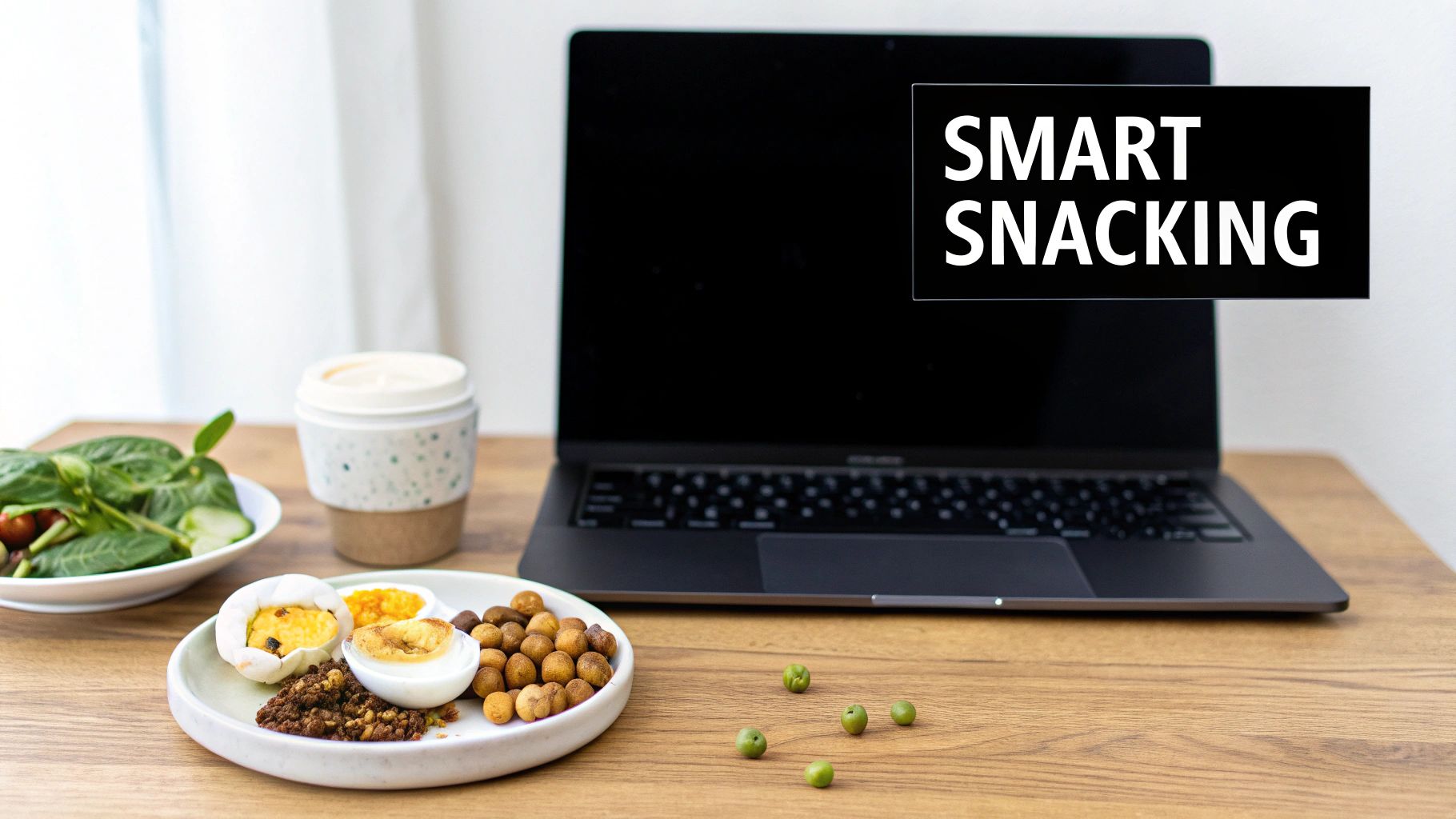 Healthy protein snacks including hard boiled eggs, roasted chickpeas, and greens on desk with laptop