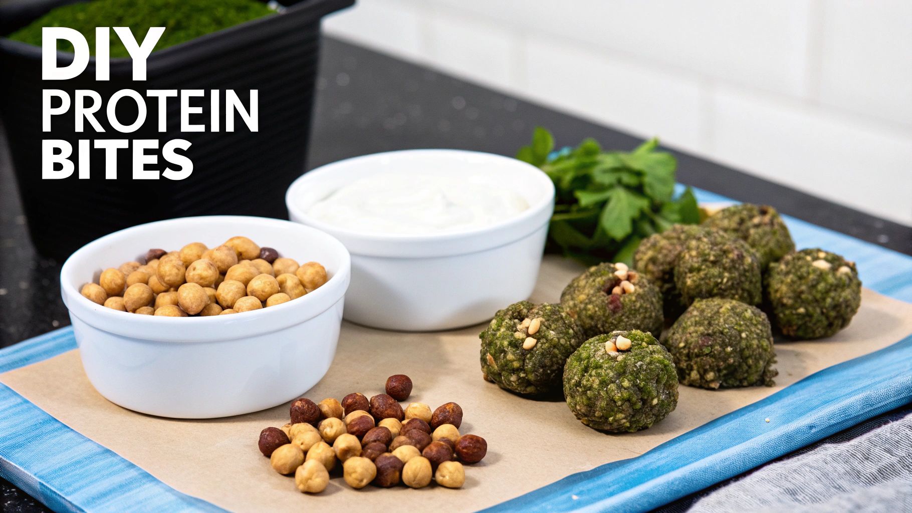 Homemade green protein bites, chickpeas, creamy dip, and fresh herbs displayed on a blue tray.