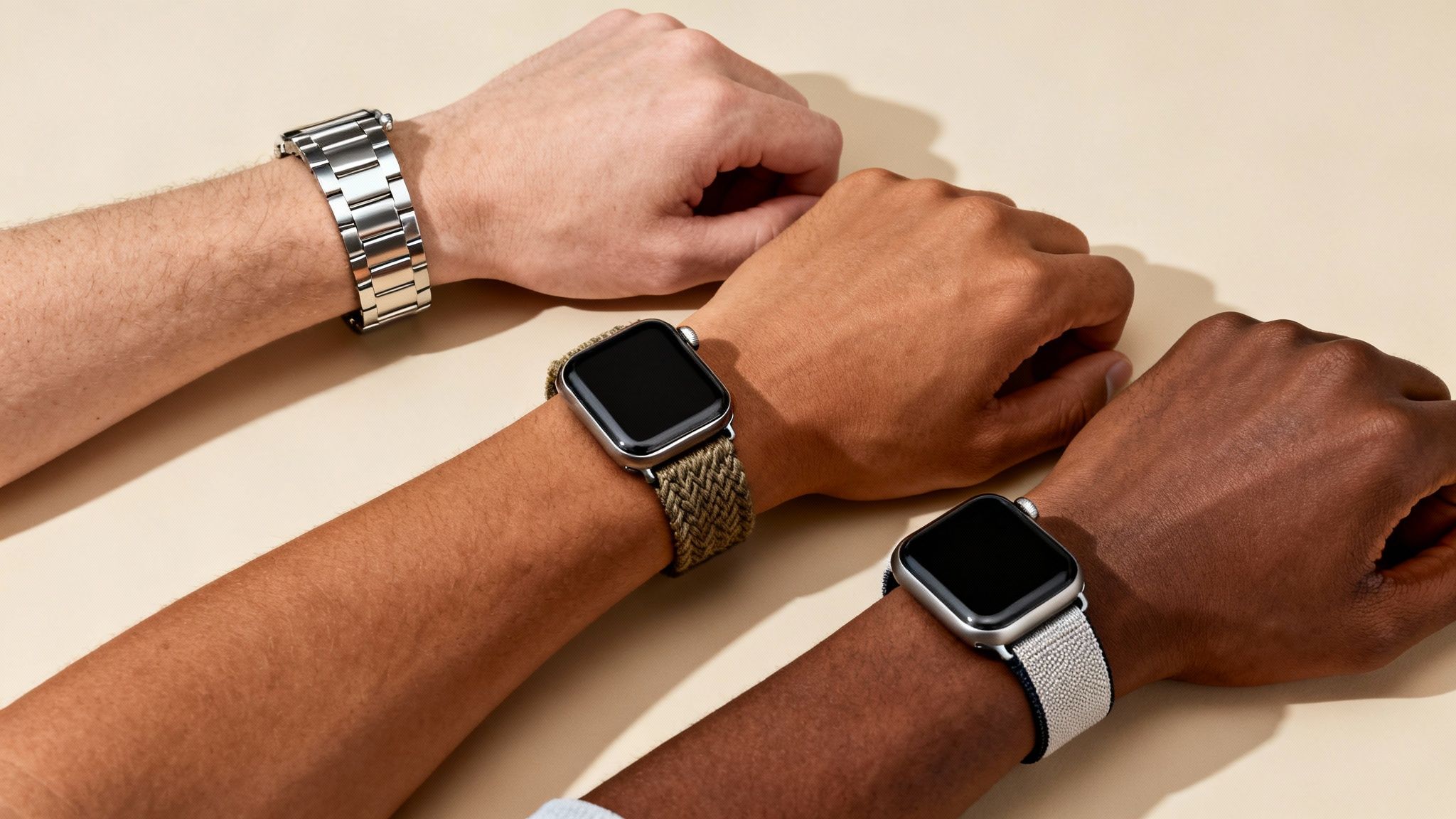 Diverse arms showcasing Apple Watches with stylish metal, green woven, and light braided bands.