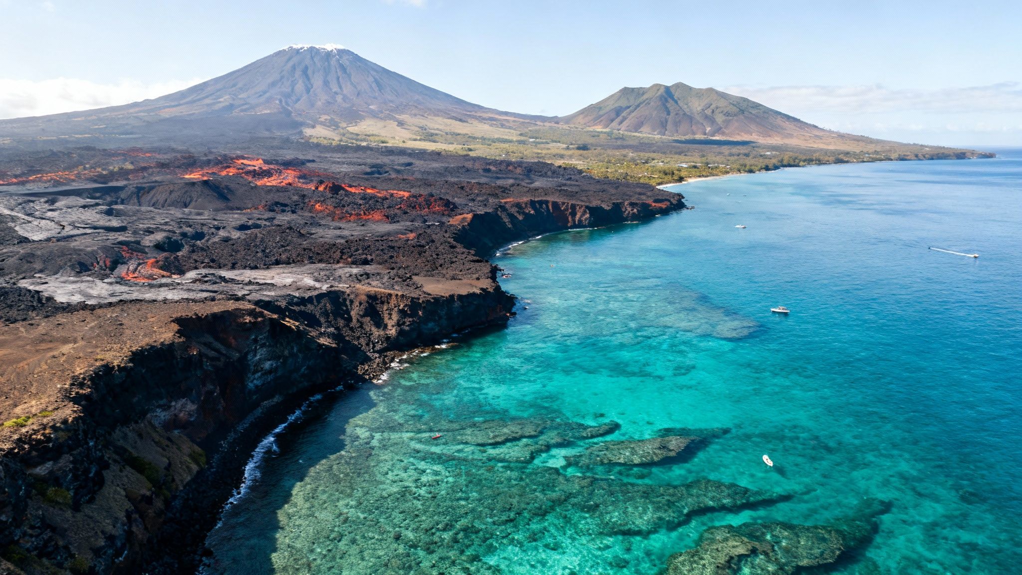Vibrant aerial view of an active volcanic island with lava flows, turquoise ocean, and boats.