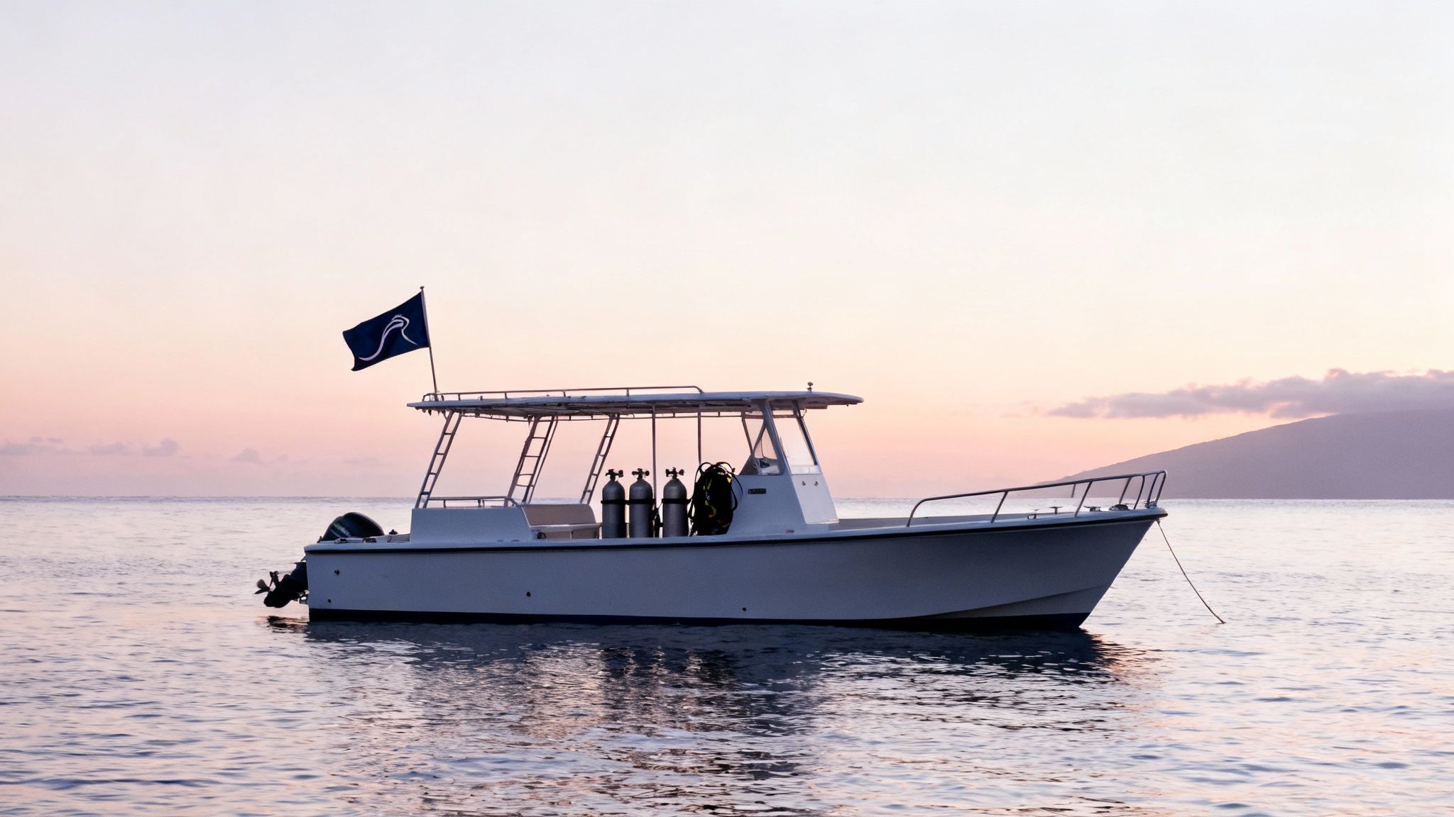 A scuba diver getting ready to enter the water from a dive boat on the Big Island.