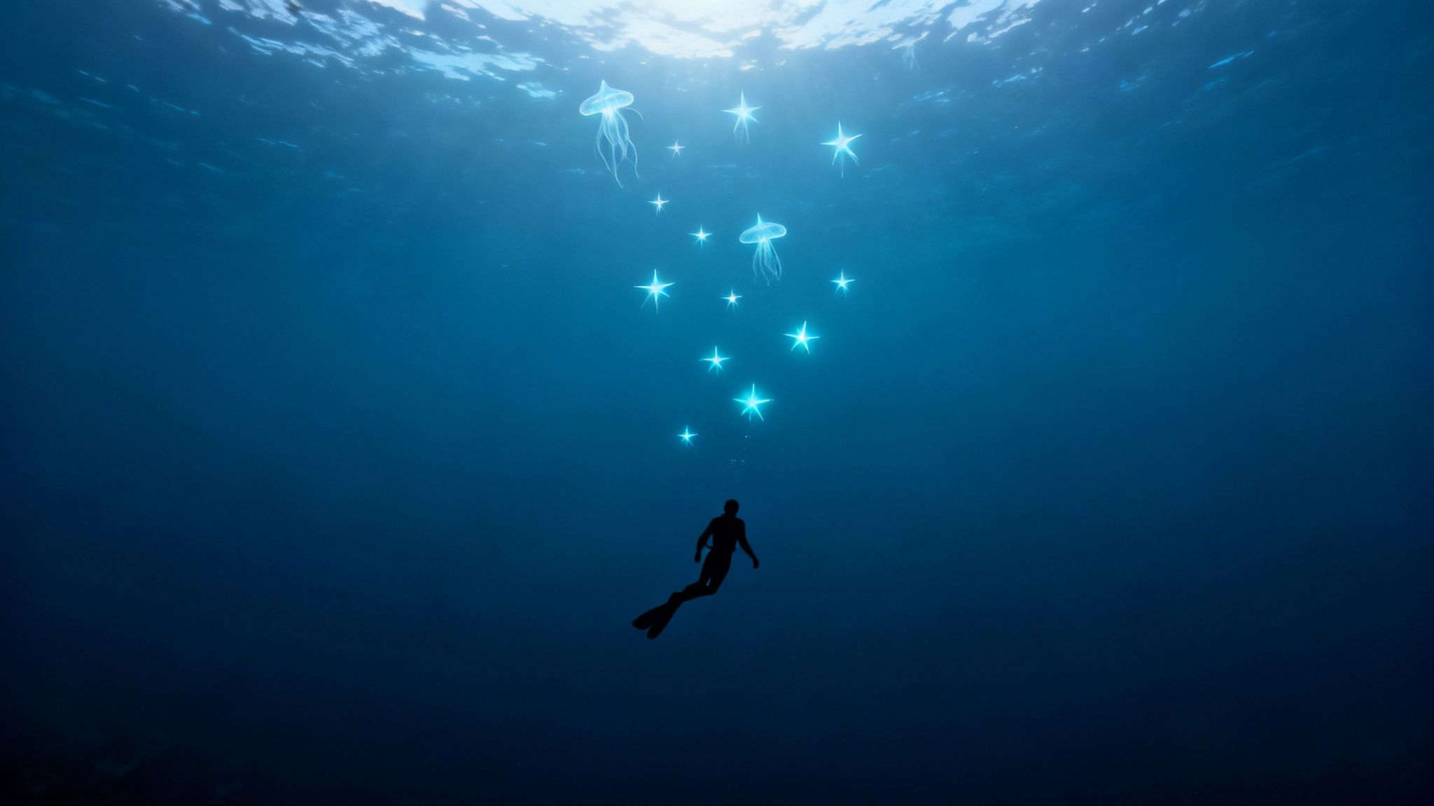 A freediver in deep blue water ascends towards the surface, surrounded by glowing stars and jellyfish.