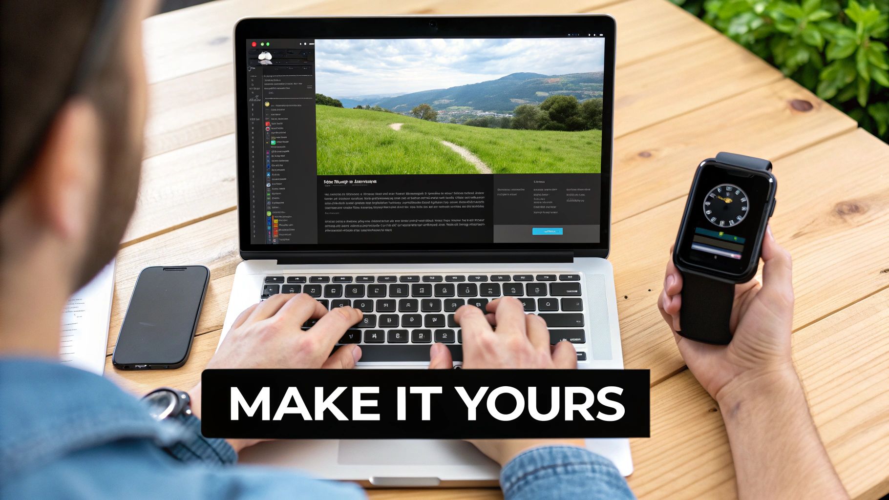 Hands typing on a laptop with a website, a smartphone, and a smartwatch on a wooden table.