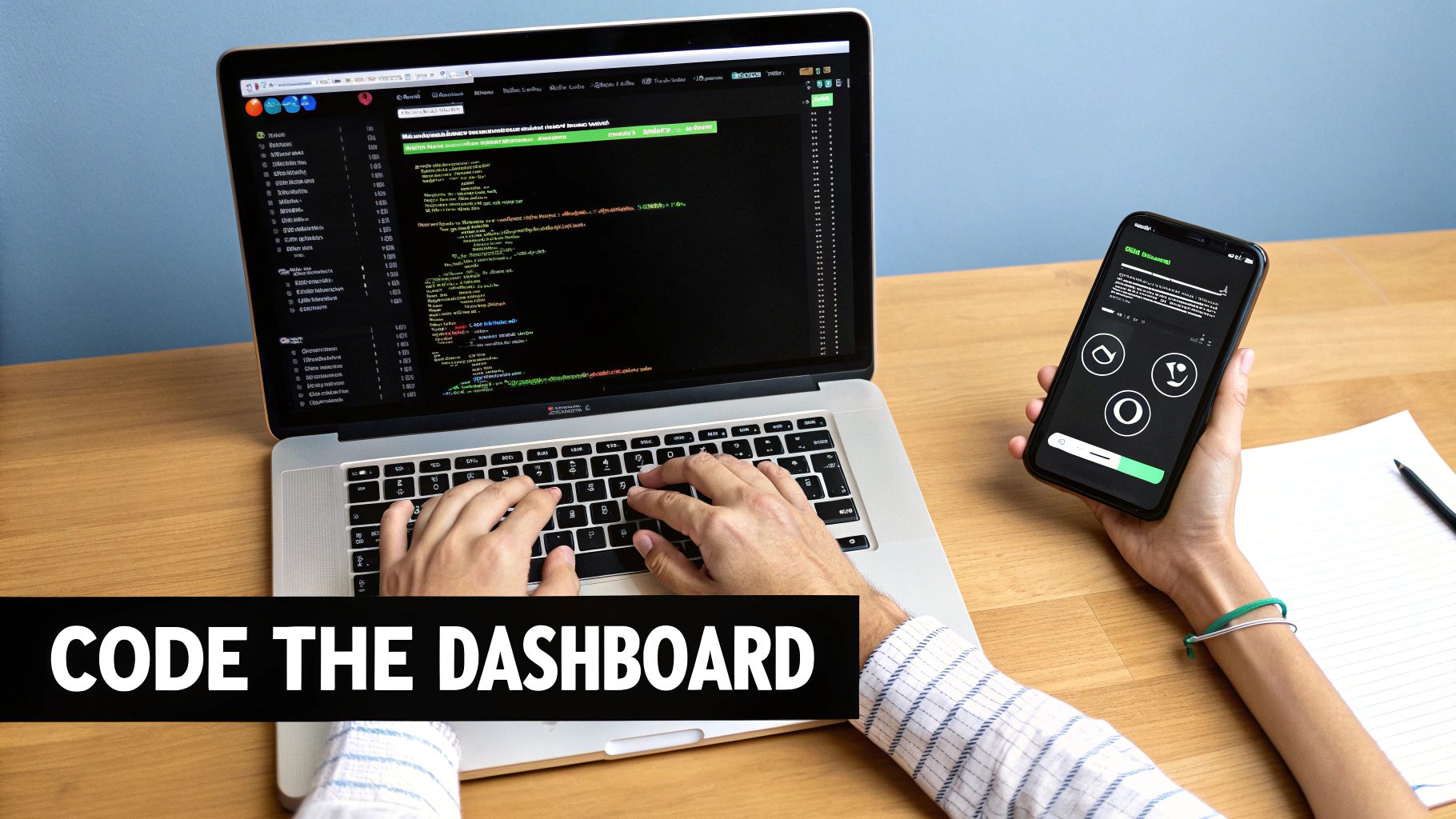 Developer's hands coding a dashboard on a laptop with a smartphone displaying an app.